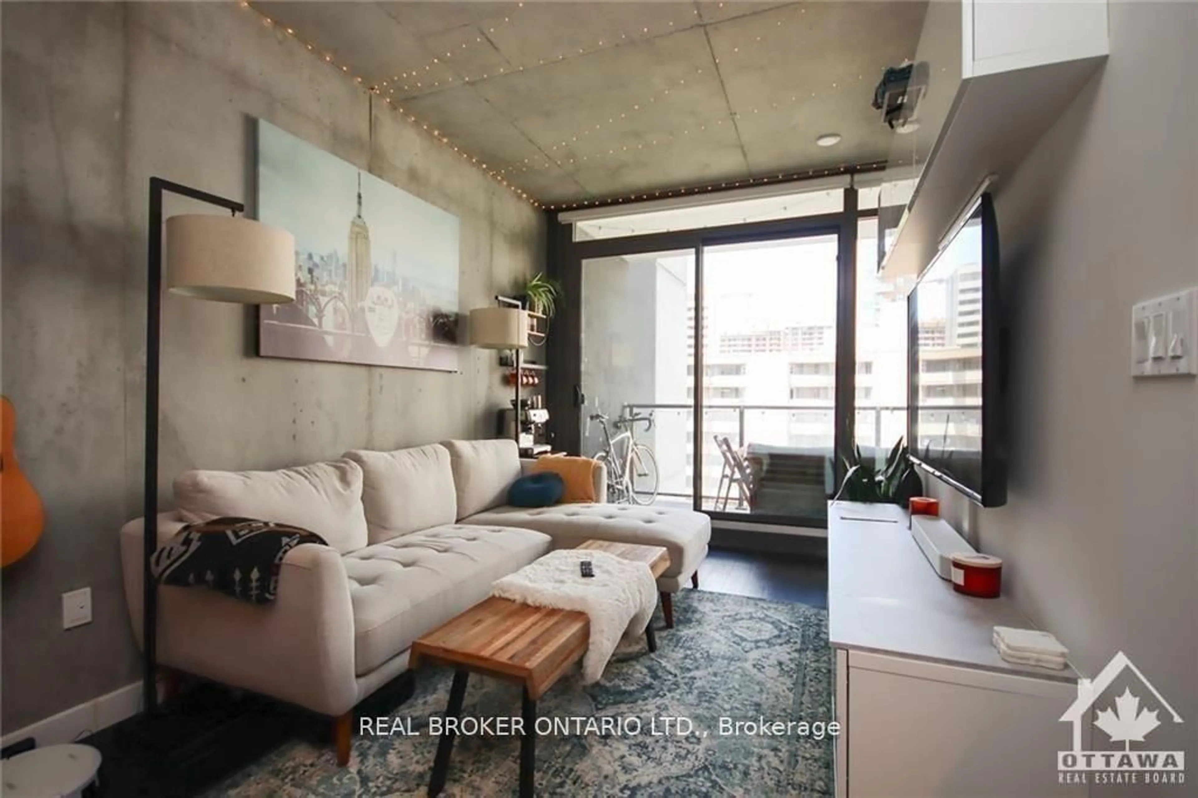 Living room with furniture, cement floor for 224 Lyon St #815, Ottawa Ontario K1R 0C1