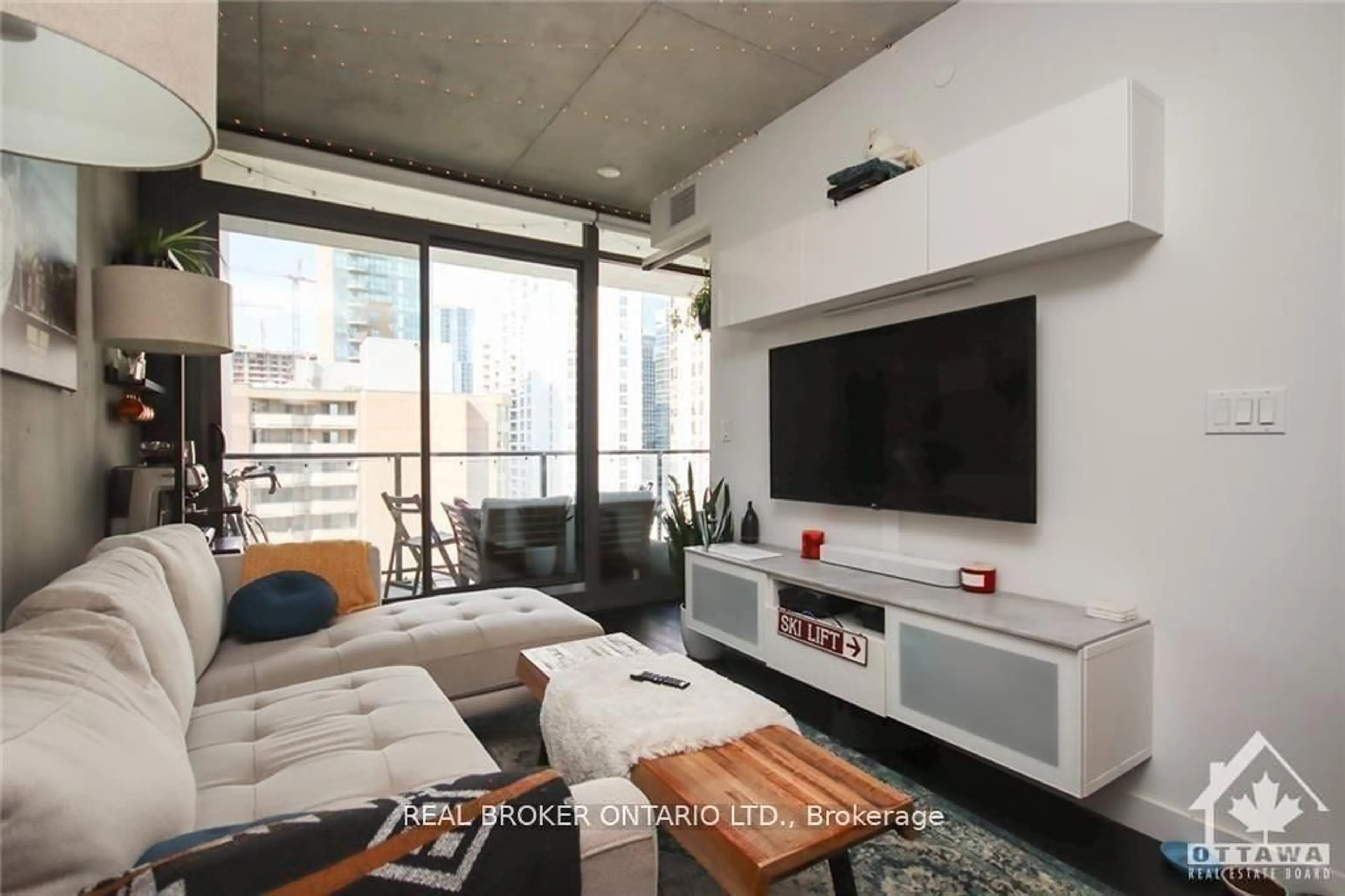 Living room with furniture, cement floor for 224 Lyon St #815, Ottawa Ontario K1R 0C1