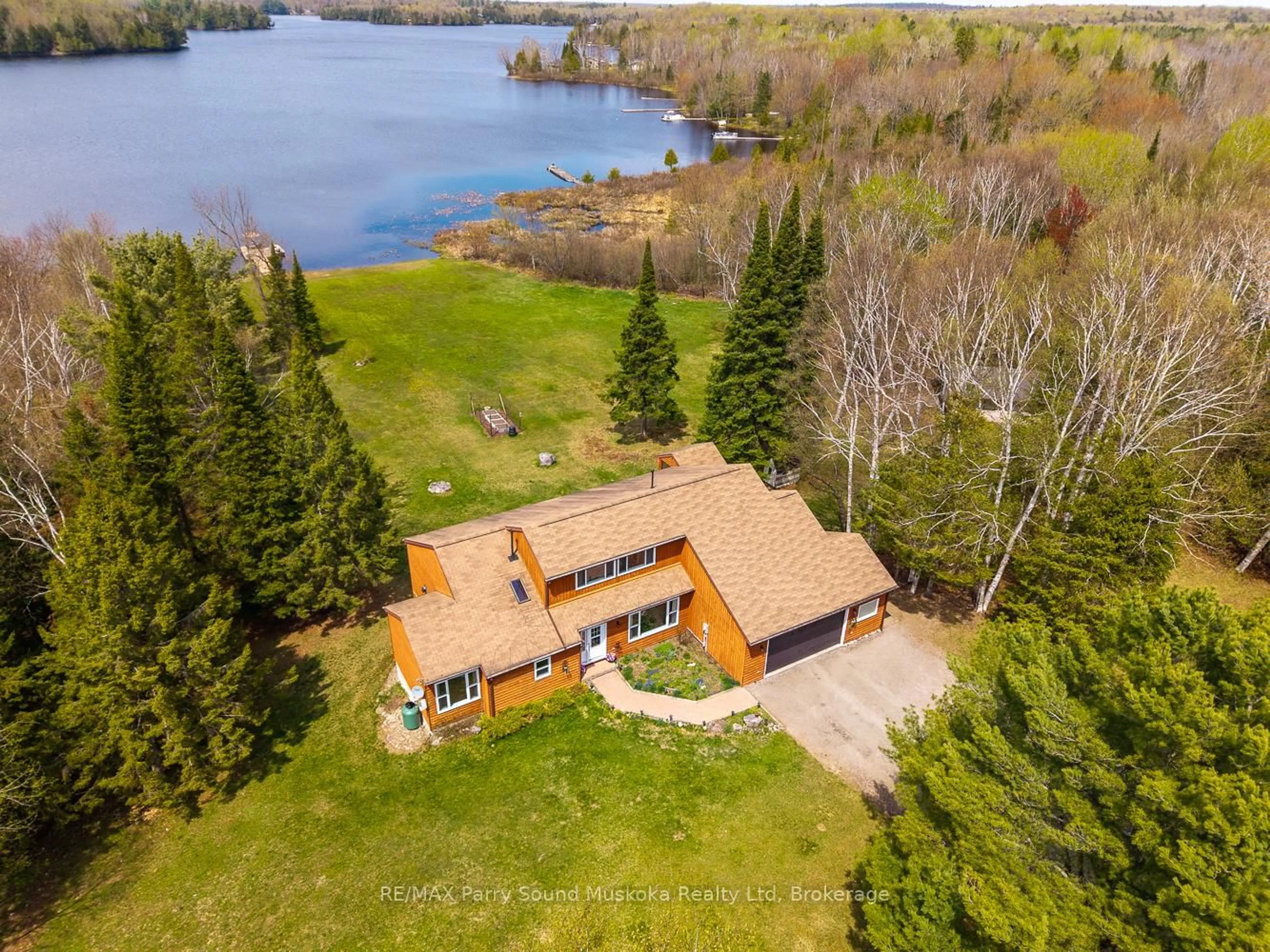 A pic from outside/outdoor area/front of a property/back of a property/a pic from drone, water/lake/river/ocean view for 258 Lakeside Tr, Magnetawan Ontario P0A 1P0