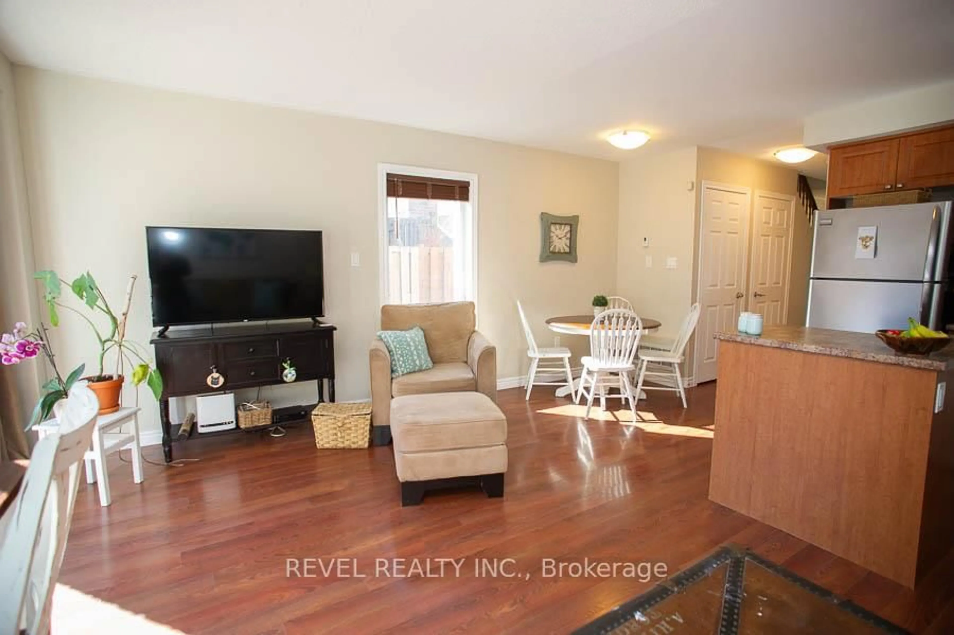 Living room with furniture, wood/laminate floor for 20 McConkey Cres #67, Brantford Ontario N3S 0C1