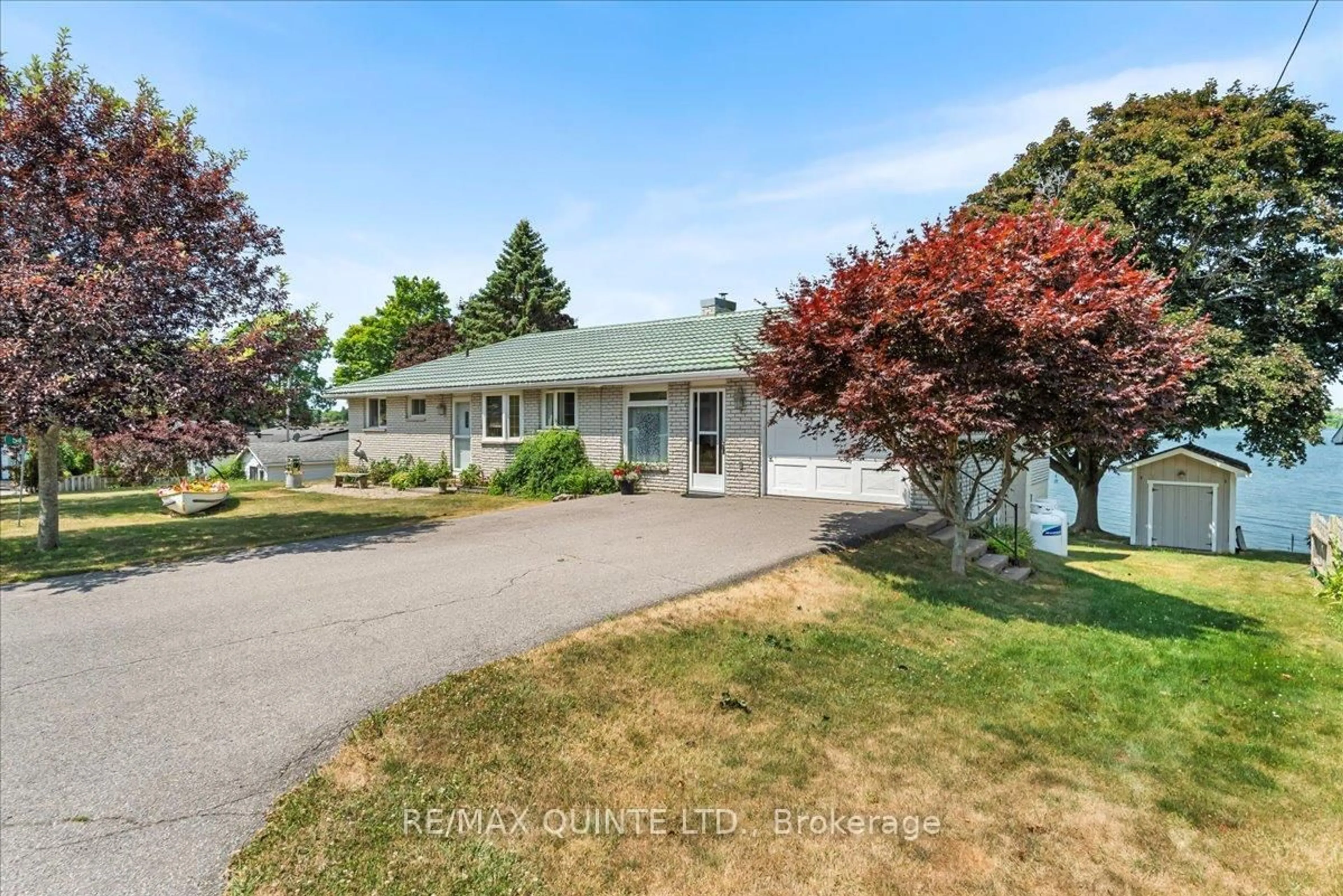 A pic from outside/outdoor area/front of a property/back of a property/a pic from drone, water/lake/river/ocean view for 54 Cedar Lane, Prince Edward County Ontario K0K 2T0