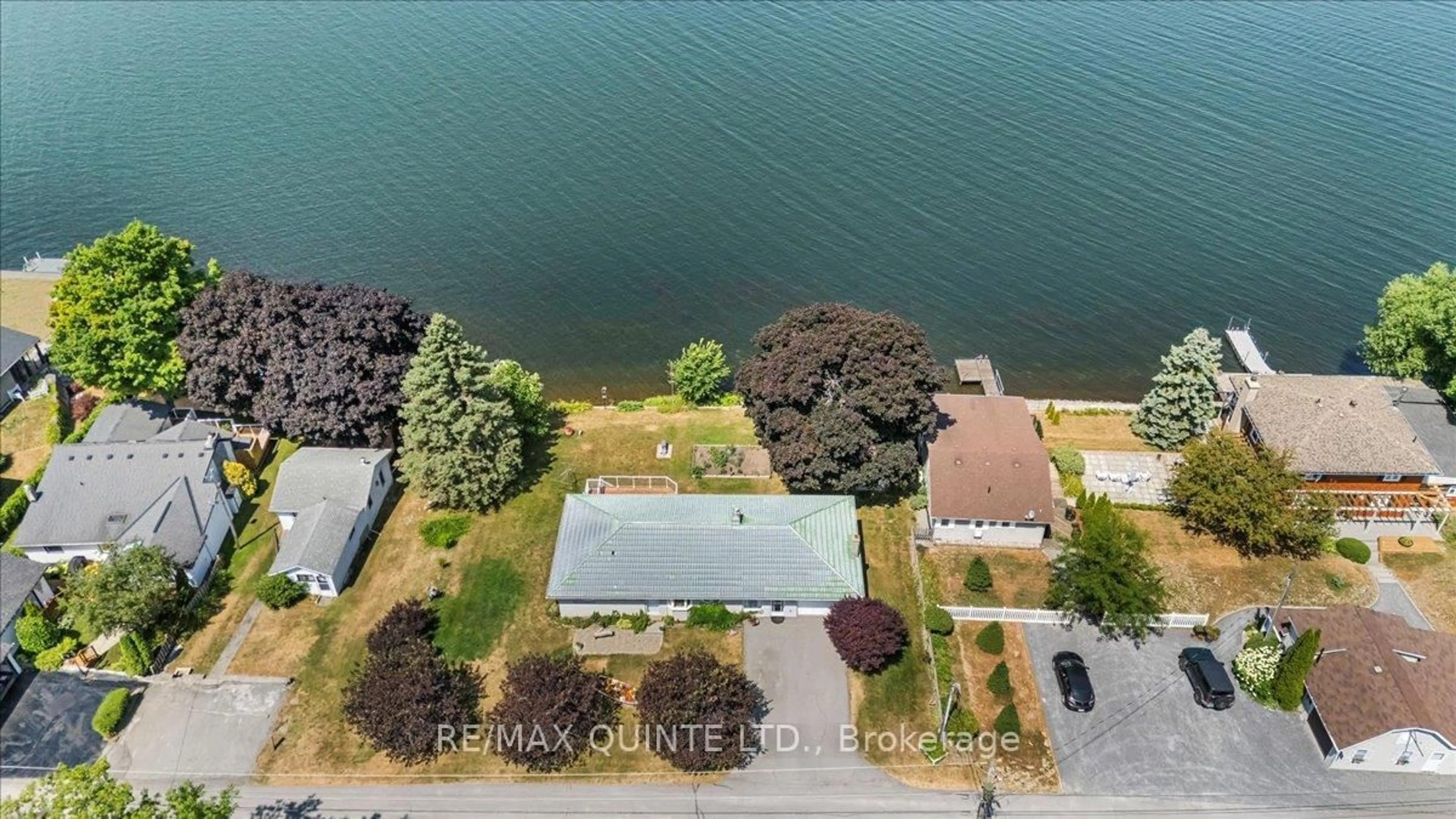 A pic from outside/outdoor area/front of a property/back of a property/a pic from drone, water/lake/river/ocean view for 54 Cedar Lane, Prince Edward County Ontario K0K 2T0