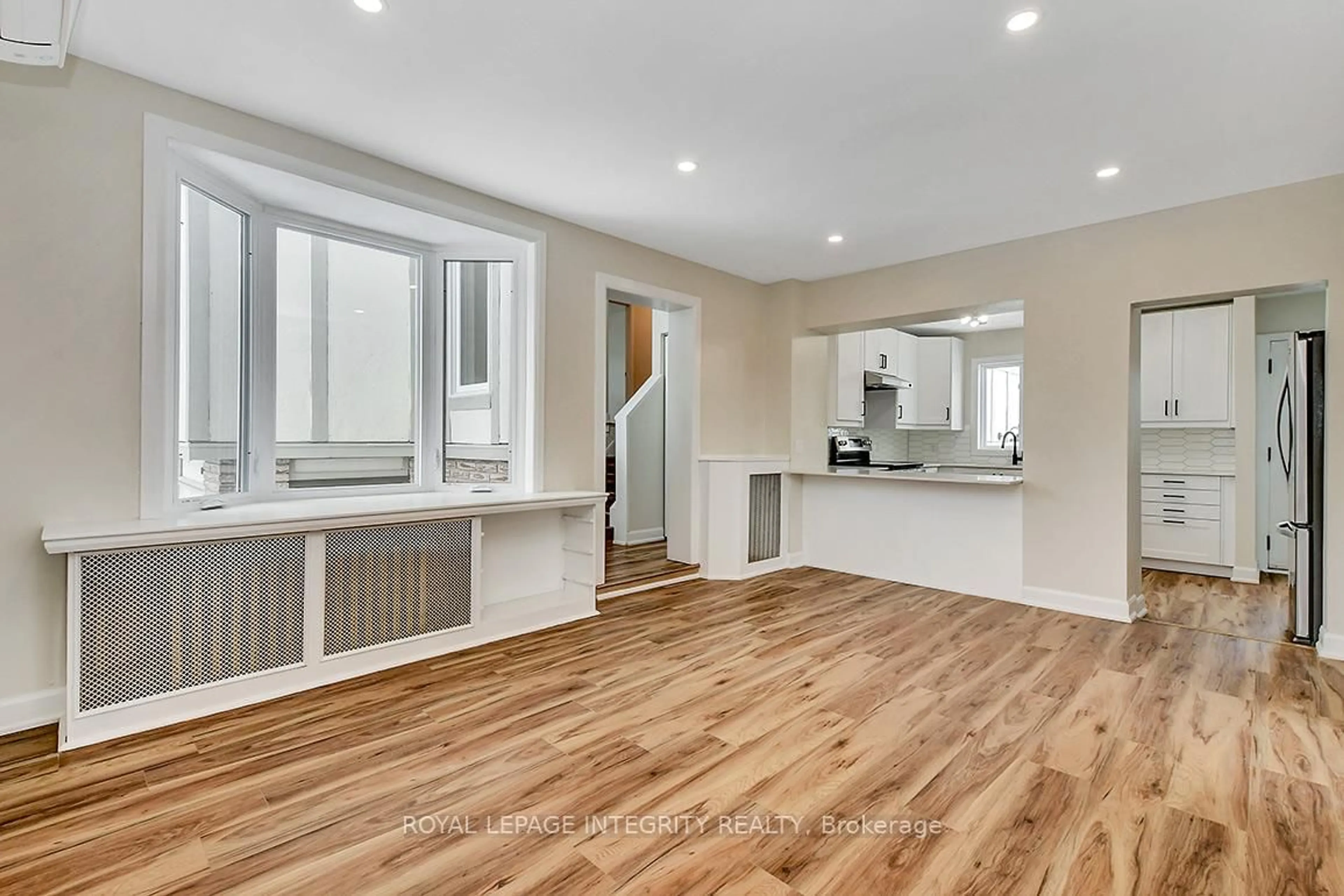 Open concept kitchen, wood/laminate floor for 301 Zephyr Ave, Ottawa Ontario K2B 5Z7