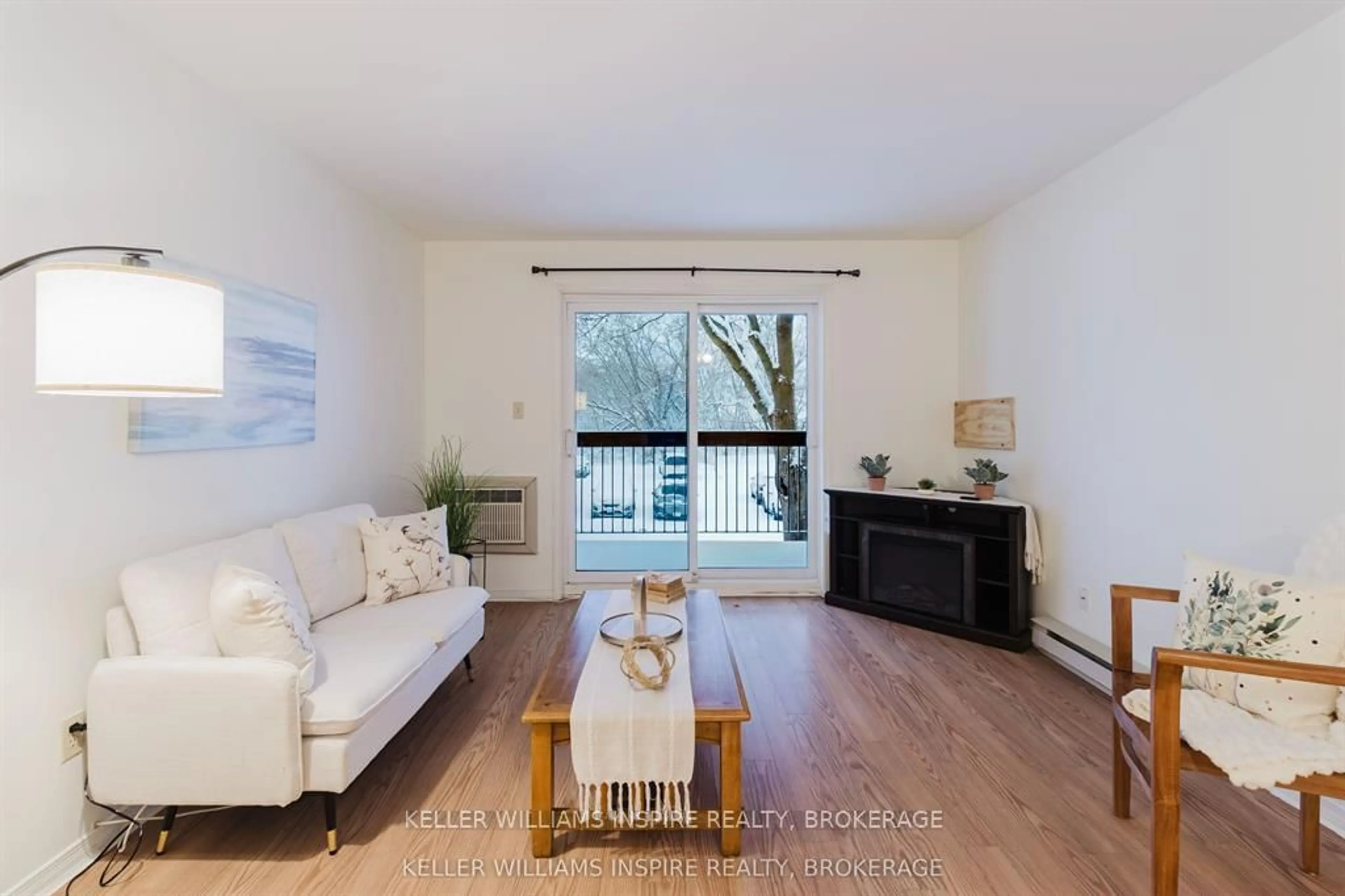 Living room with furniture, wood/laminate floor for 1100 Millwood Ave #211, Brockville Ontario K6V 6Z3
