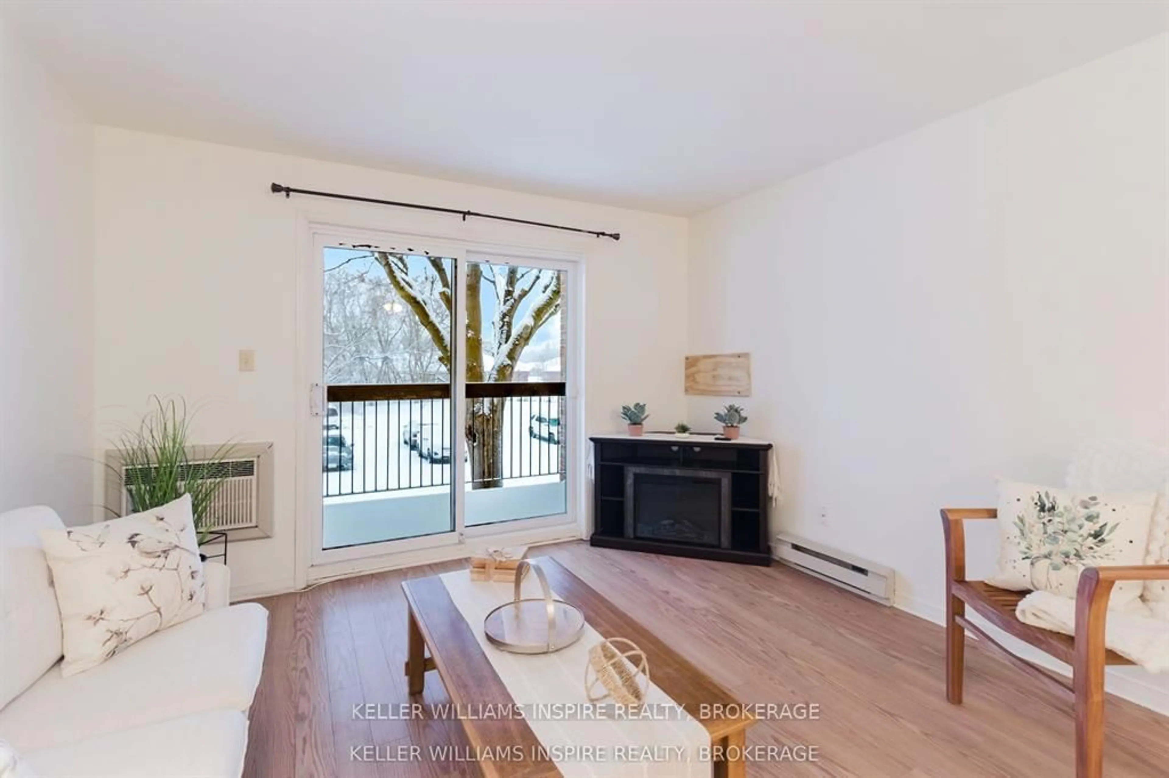 Living room with furniture, wood/laminate floor for 1100 Millwood Ave #211, Brockville Ontario K6V 6Z3