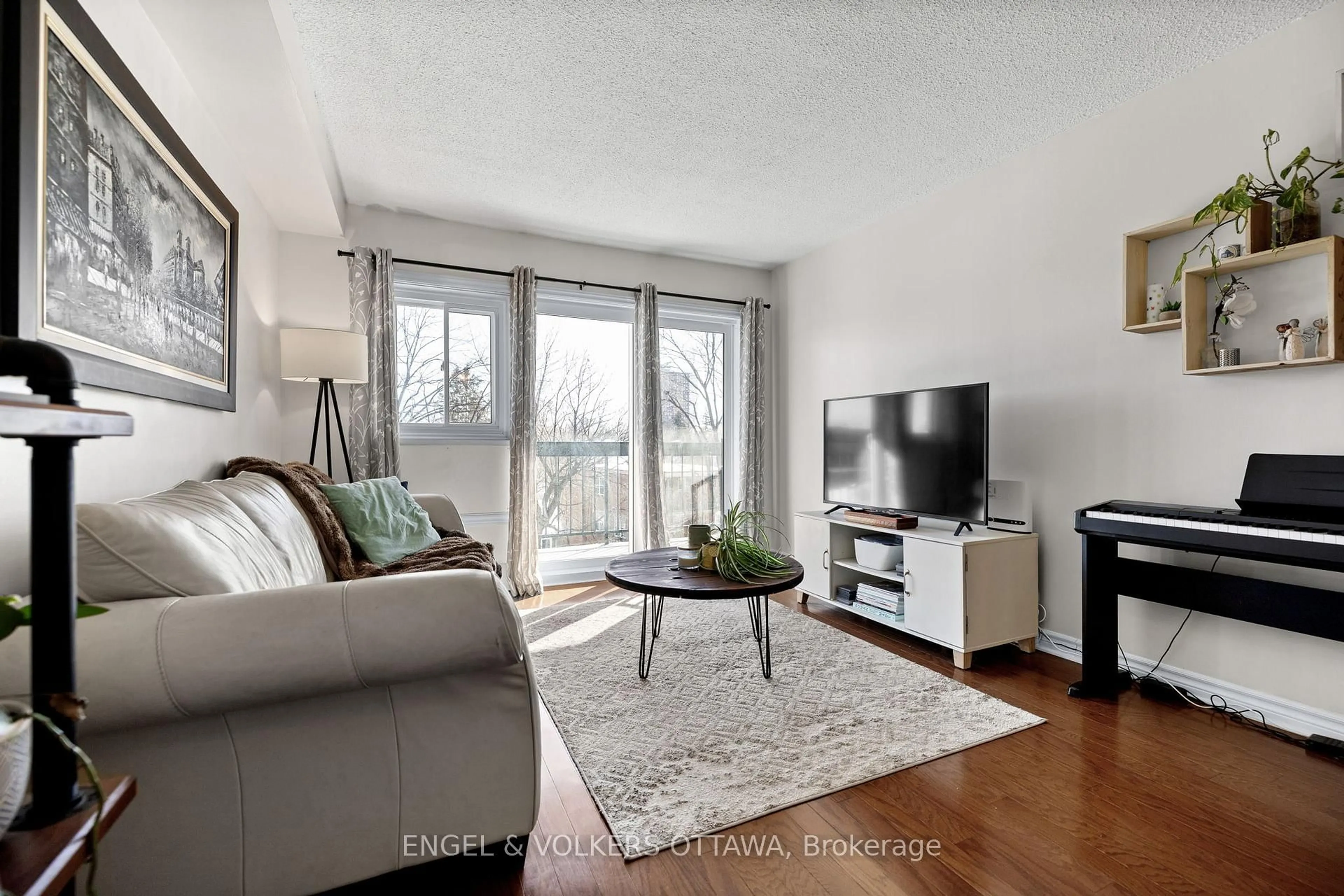 Living room with furniture, wood/laminate floor for 158A Mcarthur Ave #303, Ottawa Ontario K1L 7E7