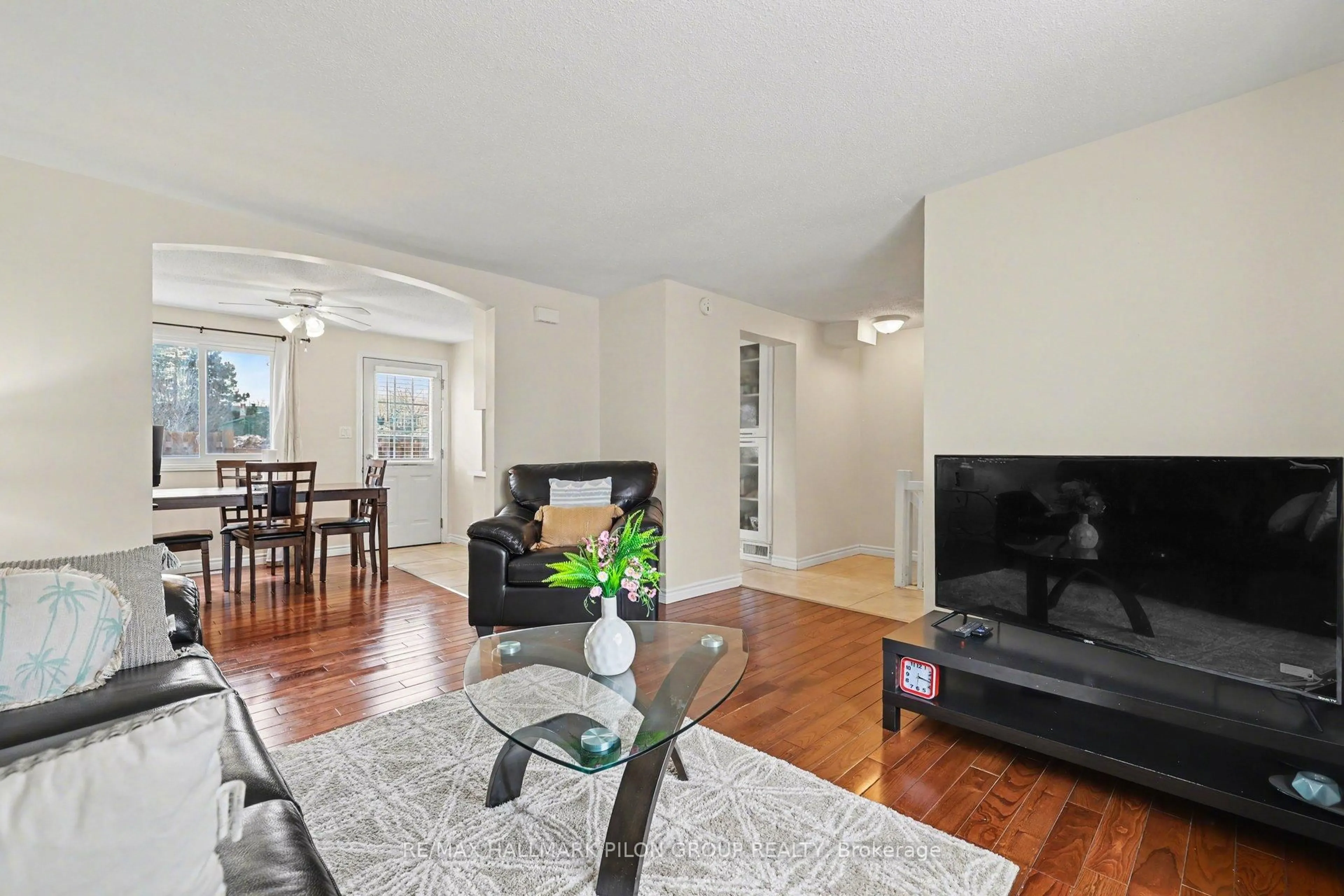 Living room with furniture, wood/laminate floor for 1540 Beaverpond Dr #C, Ottawa Ontario K1B 3R9