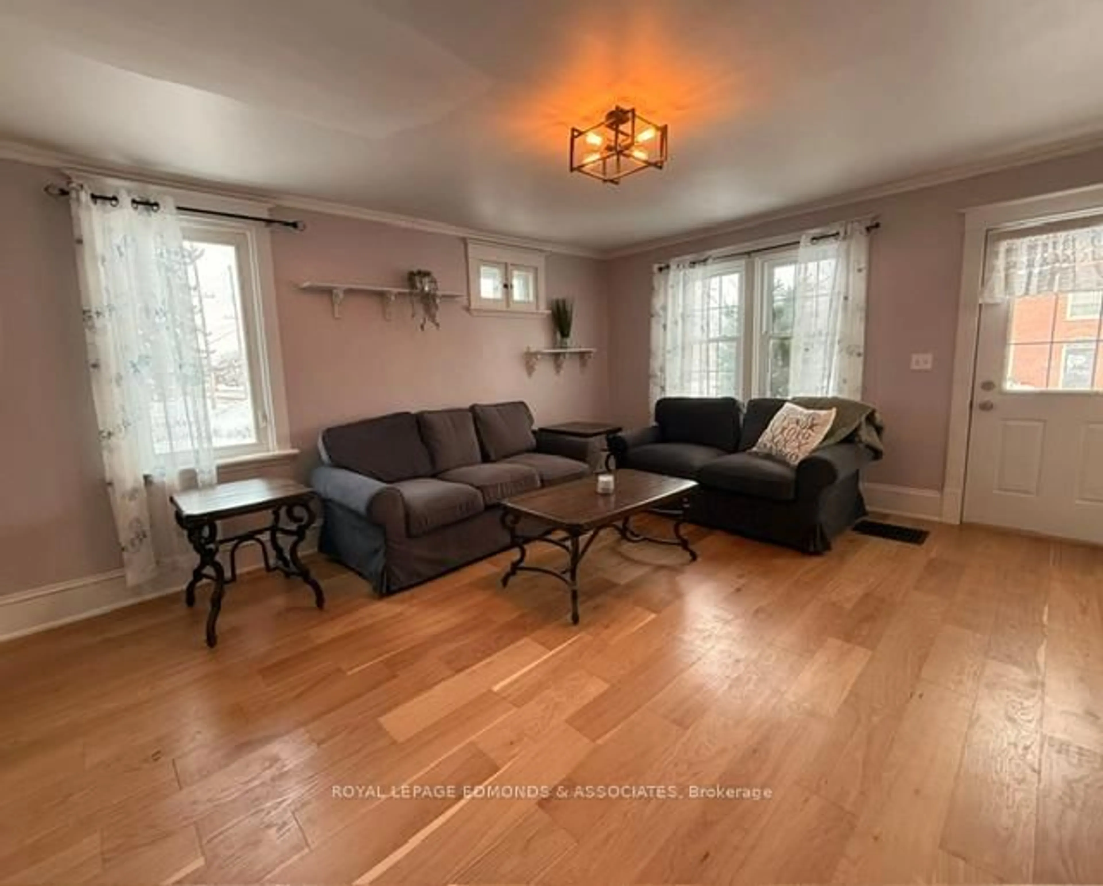 Living room with furniture, wood/laminate floor for 1028 Pembroke St, Pembroke Ontario K8A 6Z2