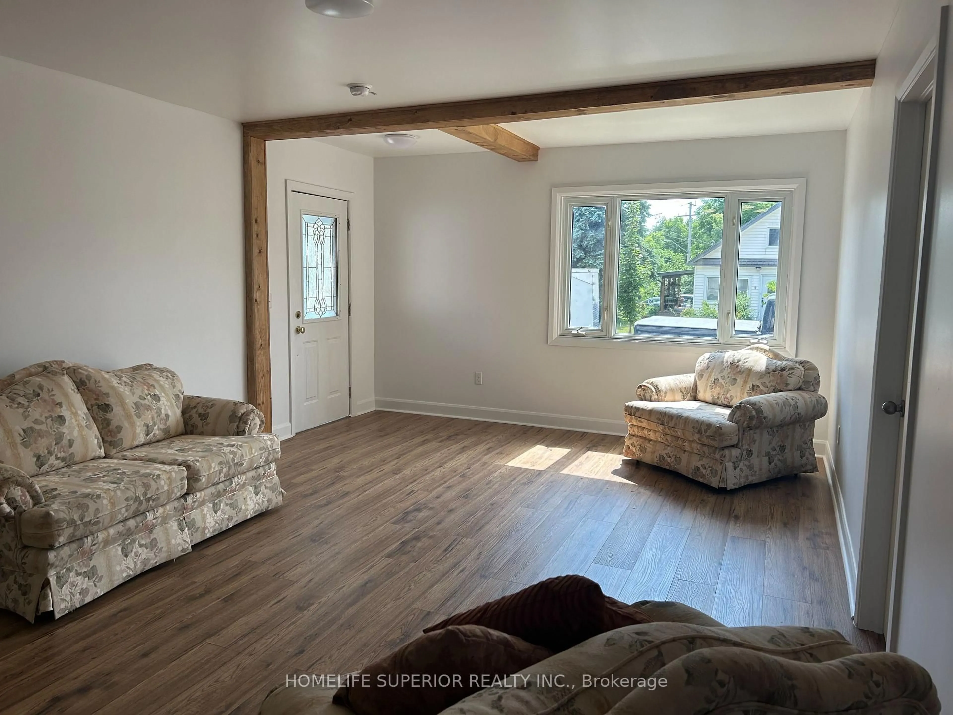 Living room with furniture, wood/laminate floor for 10 Main St, Limoges Ontario K0K 2M0