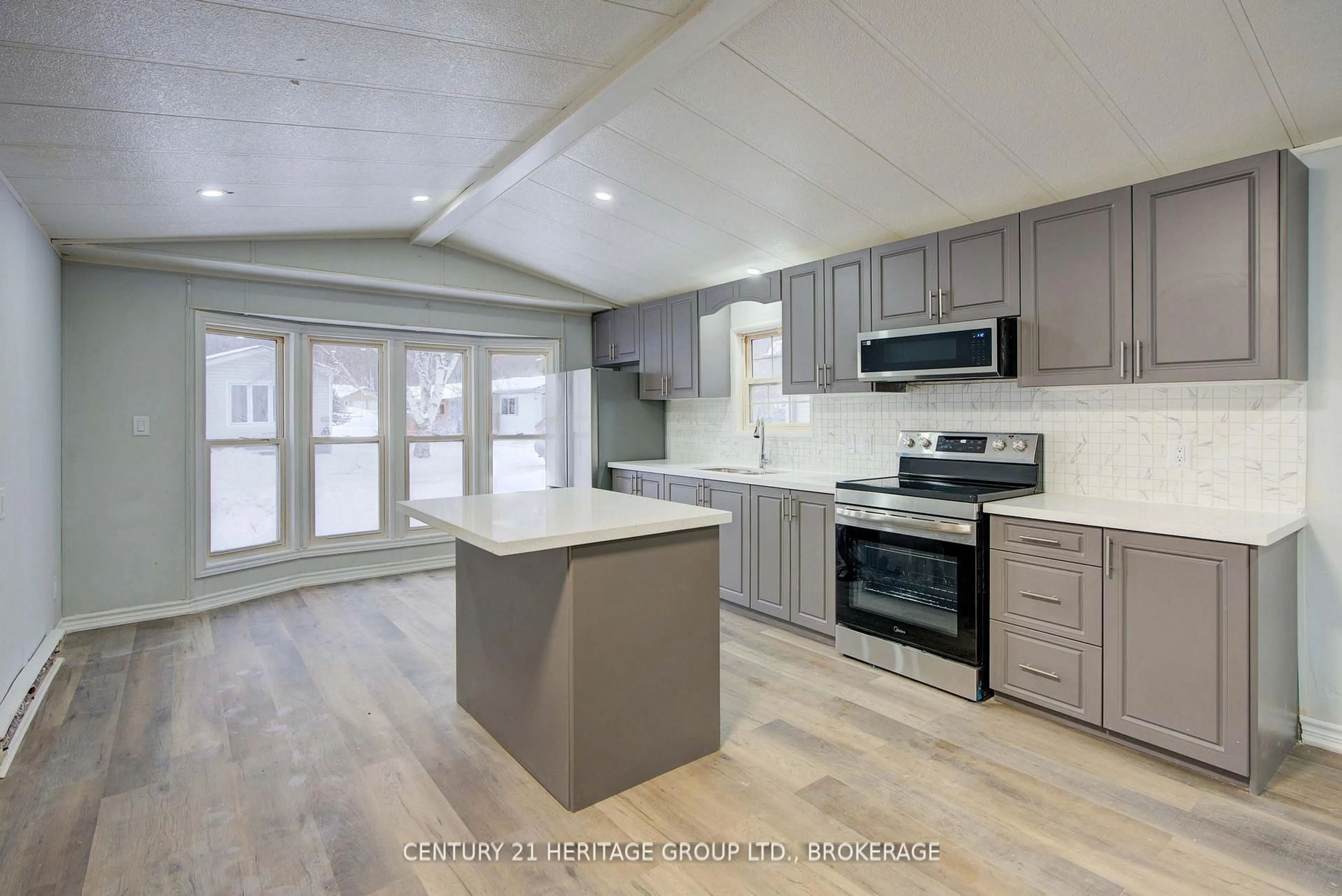 Open concept kitchen, wood/laminate floor for 227 Big Hill Rd #35, Leeds and the Thousand Islands Ontario K0H 2N0