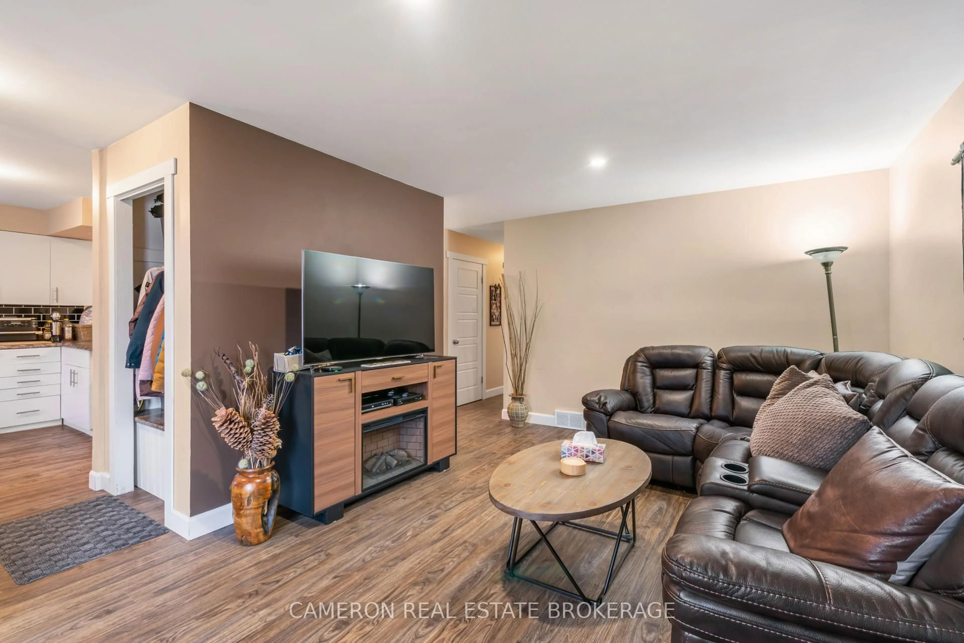 Living room with furniture, wood/laminate floor for 663 Hamilton Cres, Cornwall Ontario K6H 5N6