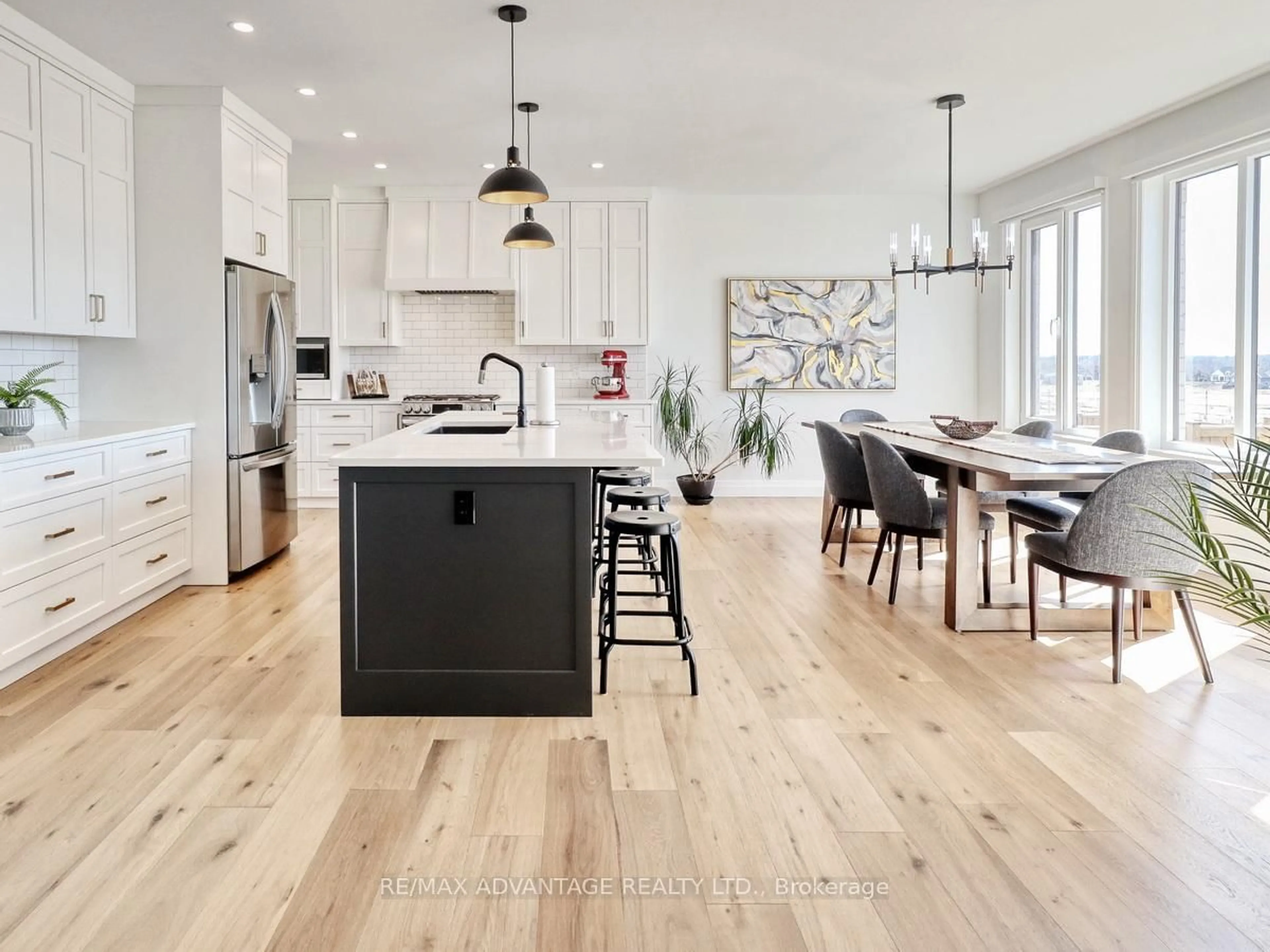 Open concept kitchen, wood/laminate floor for 73 Crestview Dr, Middlesex Centre Ontario N0L 1P0