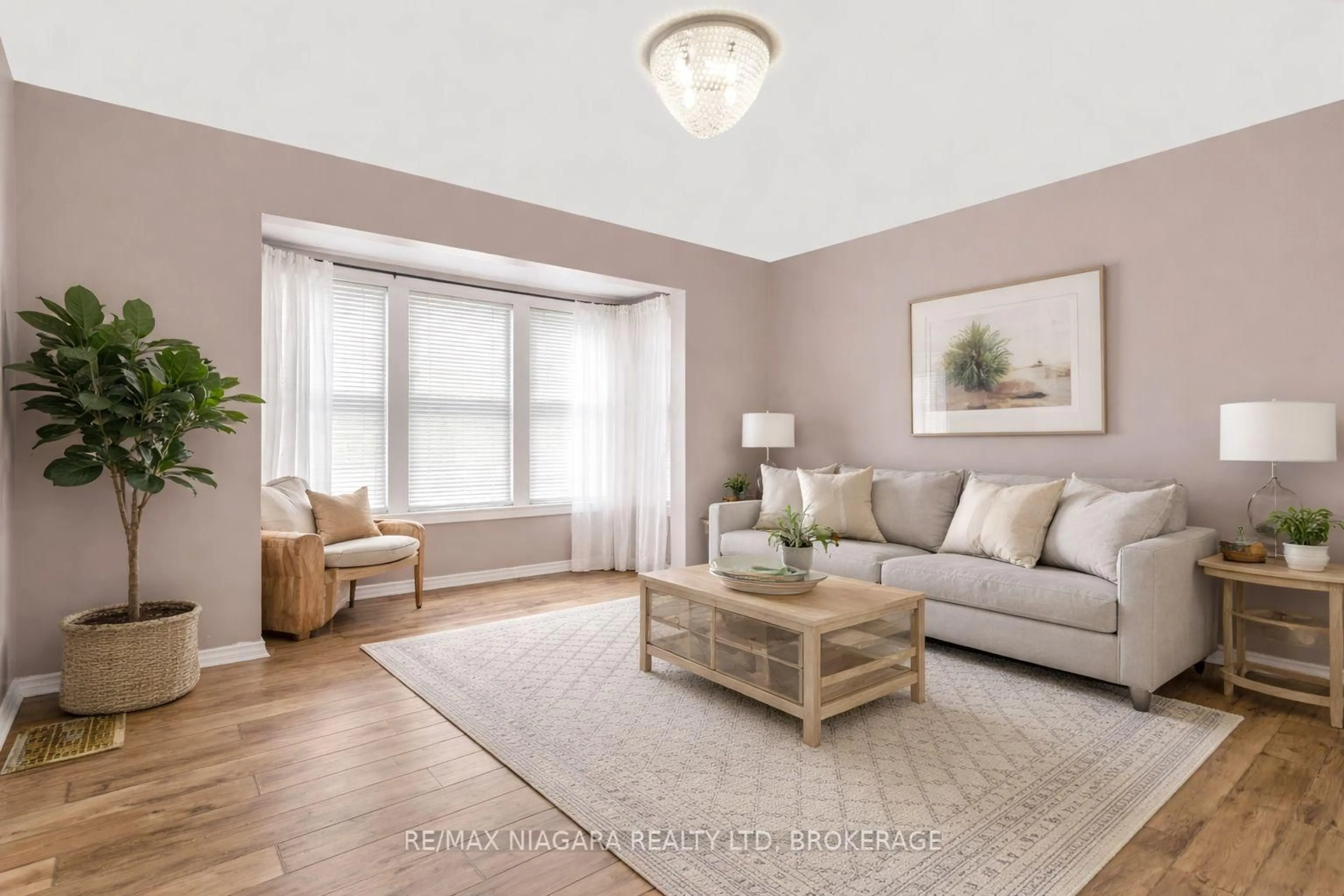 Living room with furniture, wood/laminate floor for 32 Page St, St. Catharines Ontario L2R 4A5