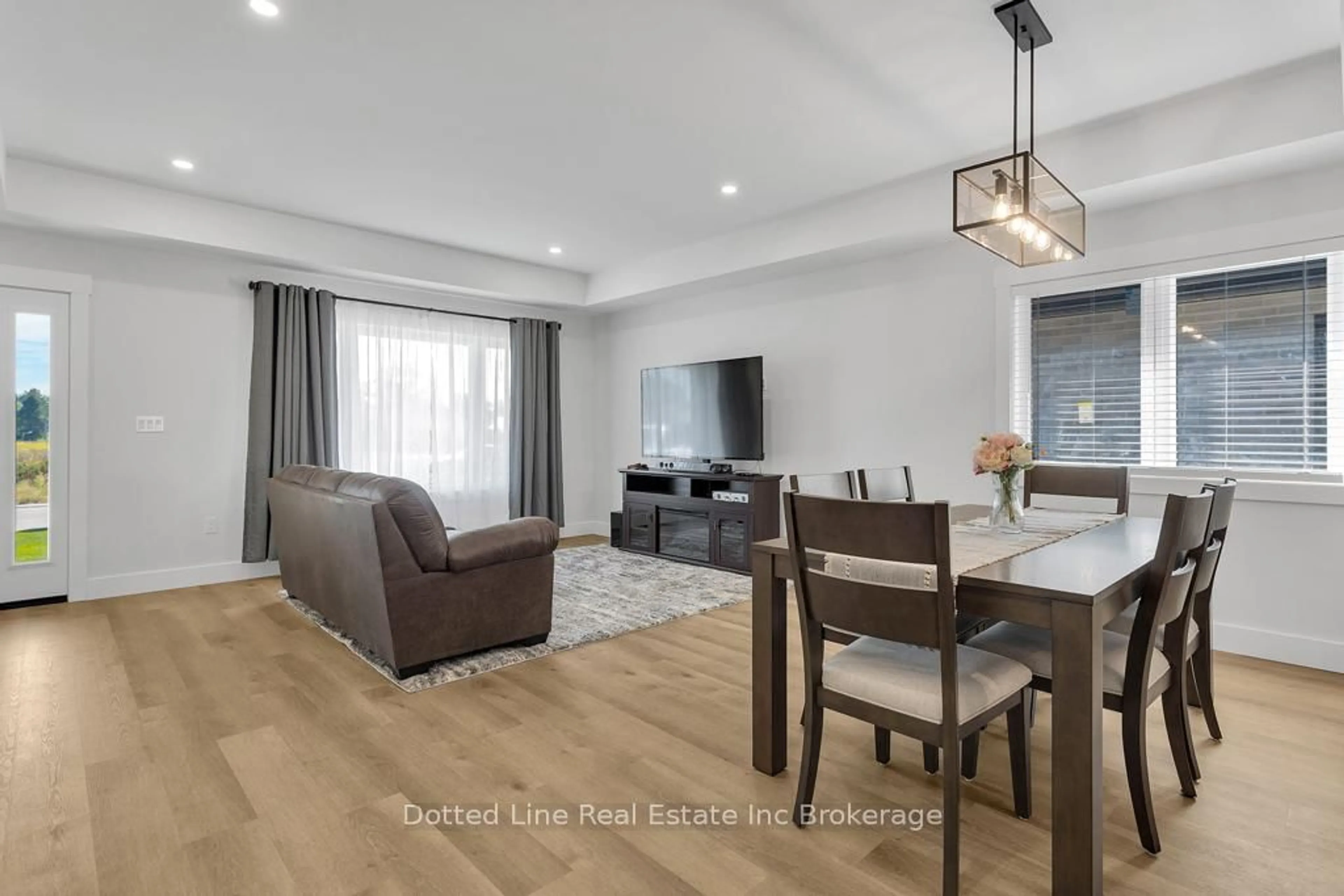 Living room with furniture, wood/laminate floor for 18 Walnut Dr, Tillsonburg Ontario N4G 5S2