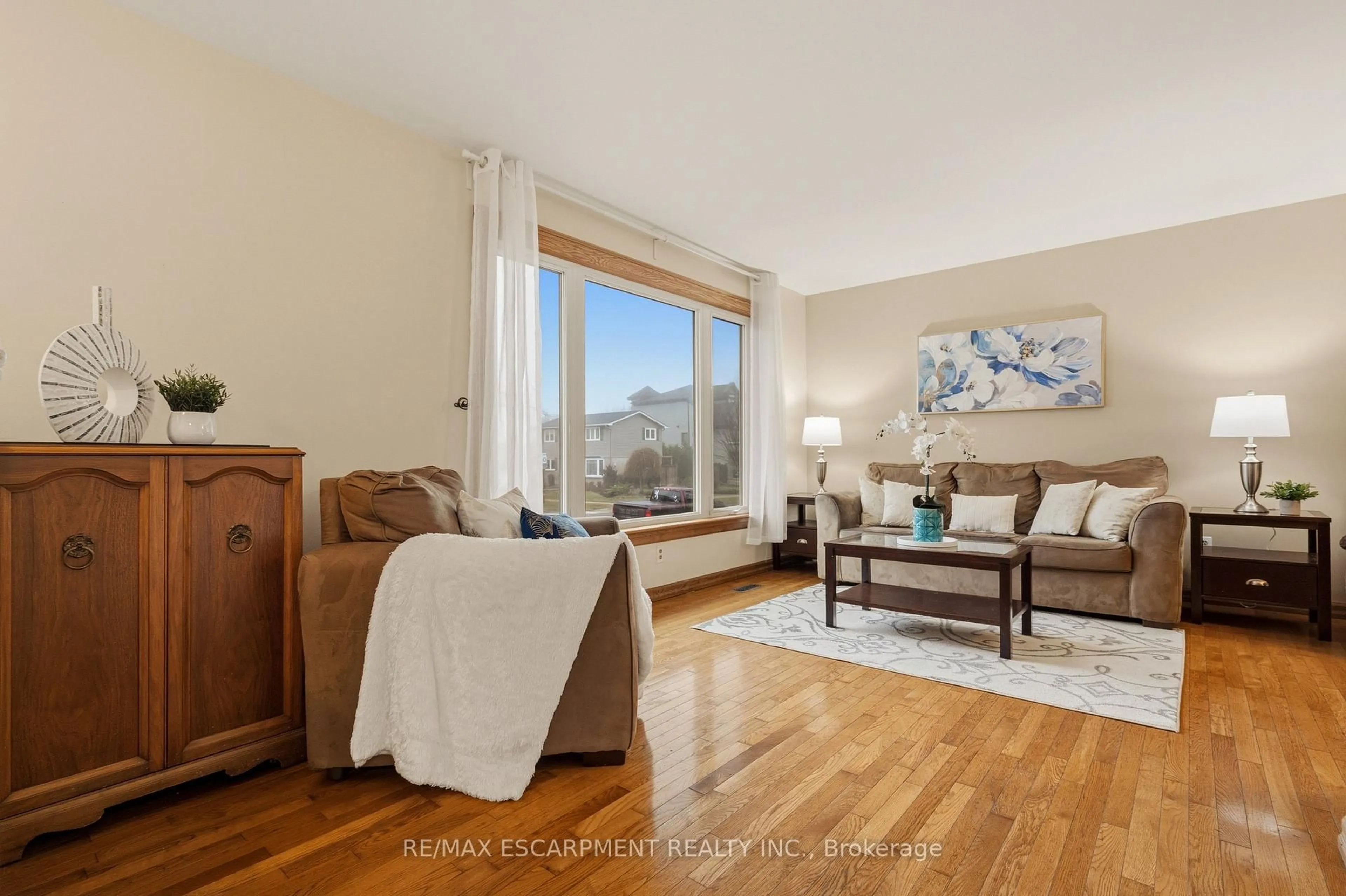 Living room with furniture, wood/laminate floor for 4 John Murray St, Hamilton Ontario L8J 1C4