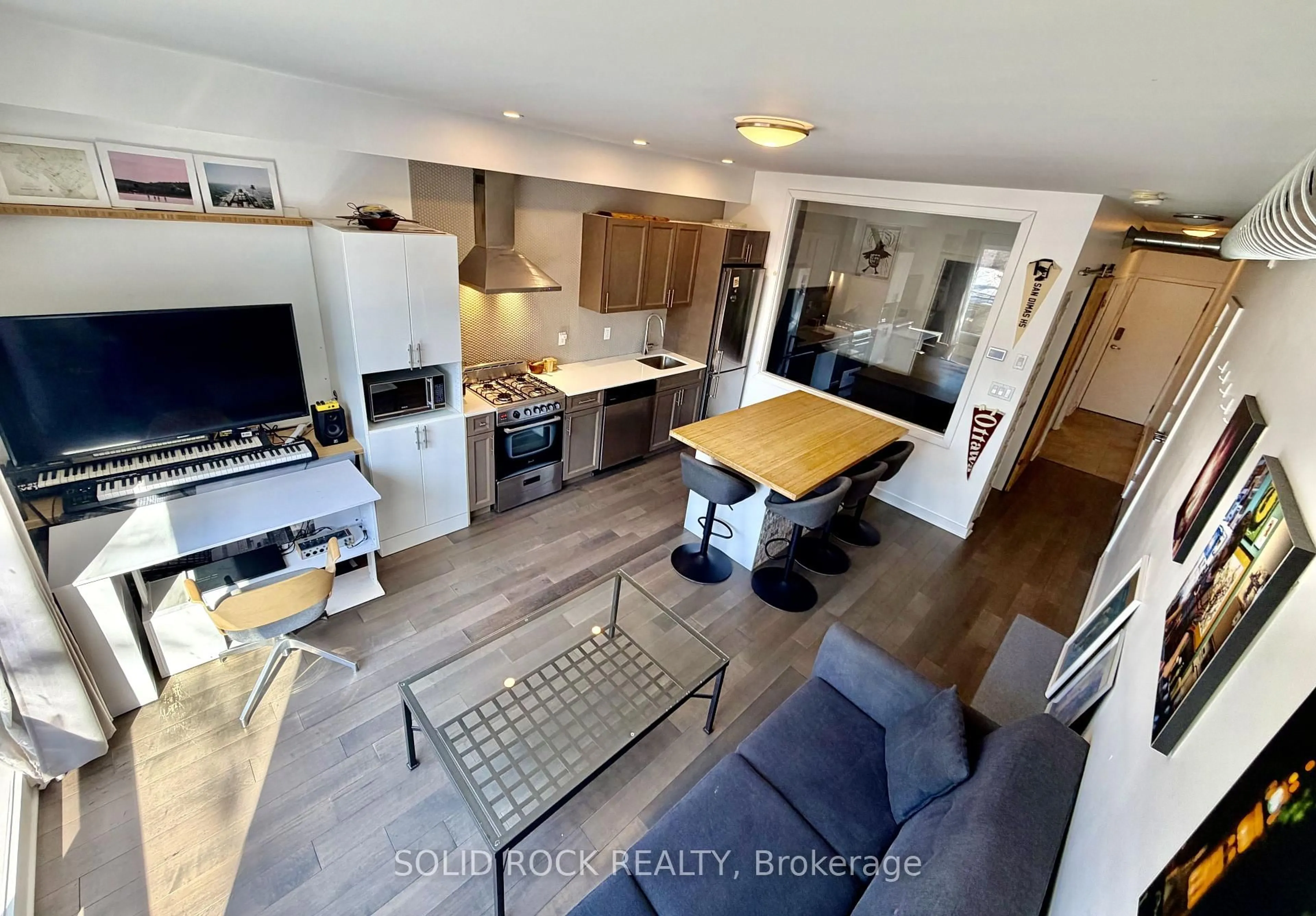 Open concept kitchen, wood/laminate floor for 22 Perkins St #204, Ottawa Ontario K1R 7G5