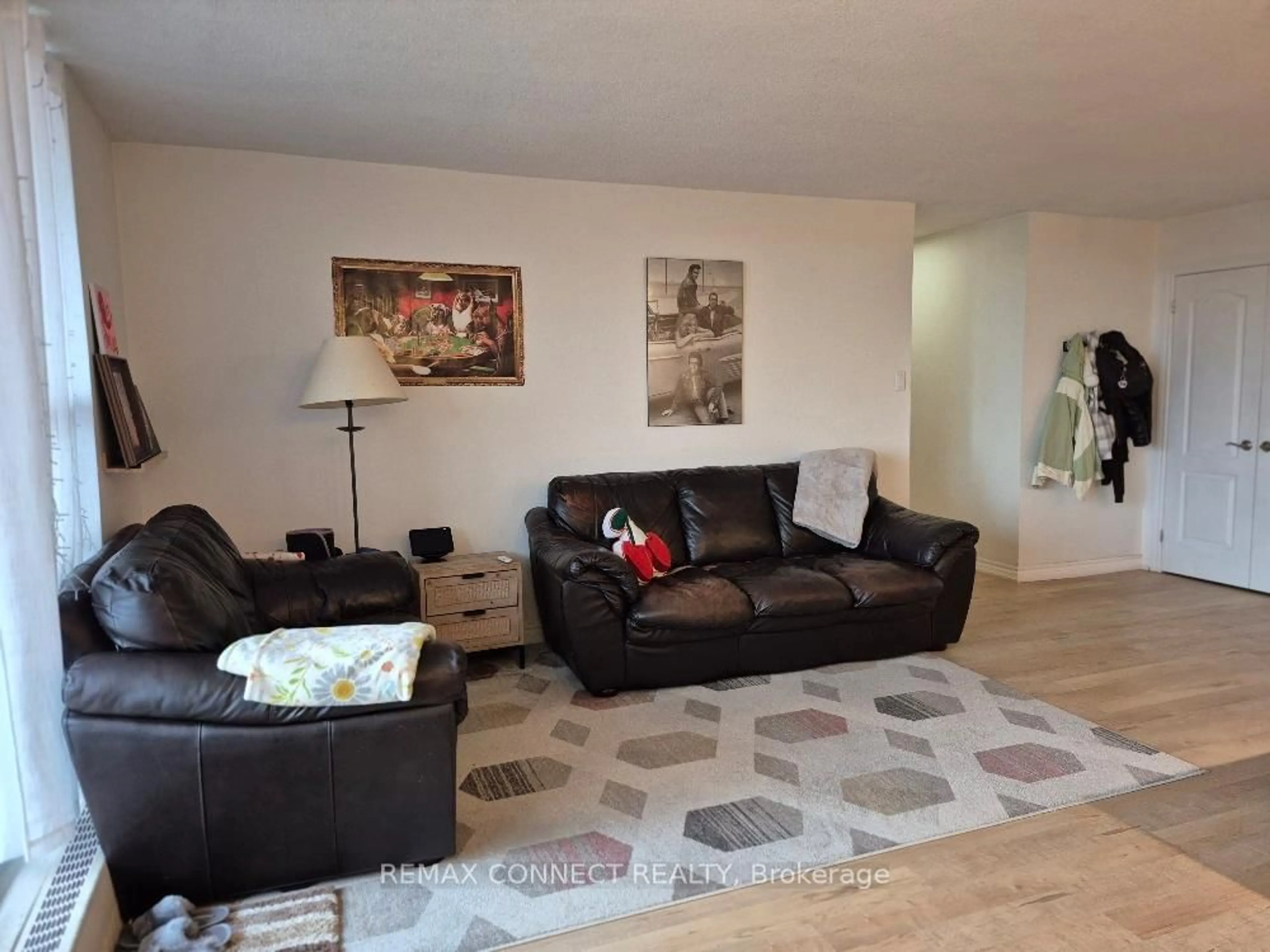 Living room with furniture, wood/laminate floor for 1964 Main St #904, Hamilton Ontario L8S 1J5