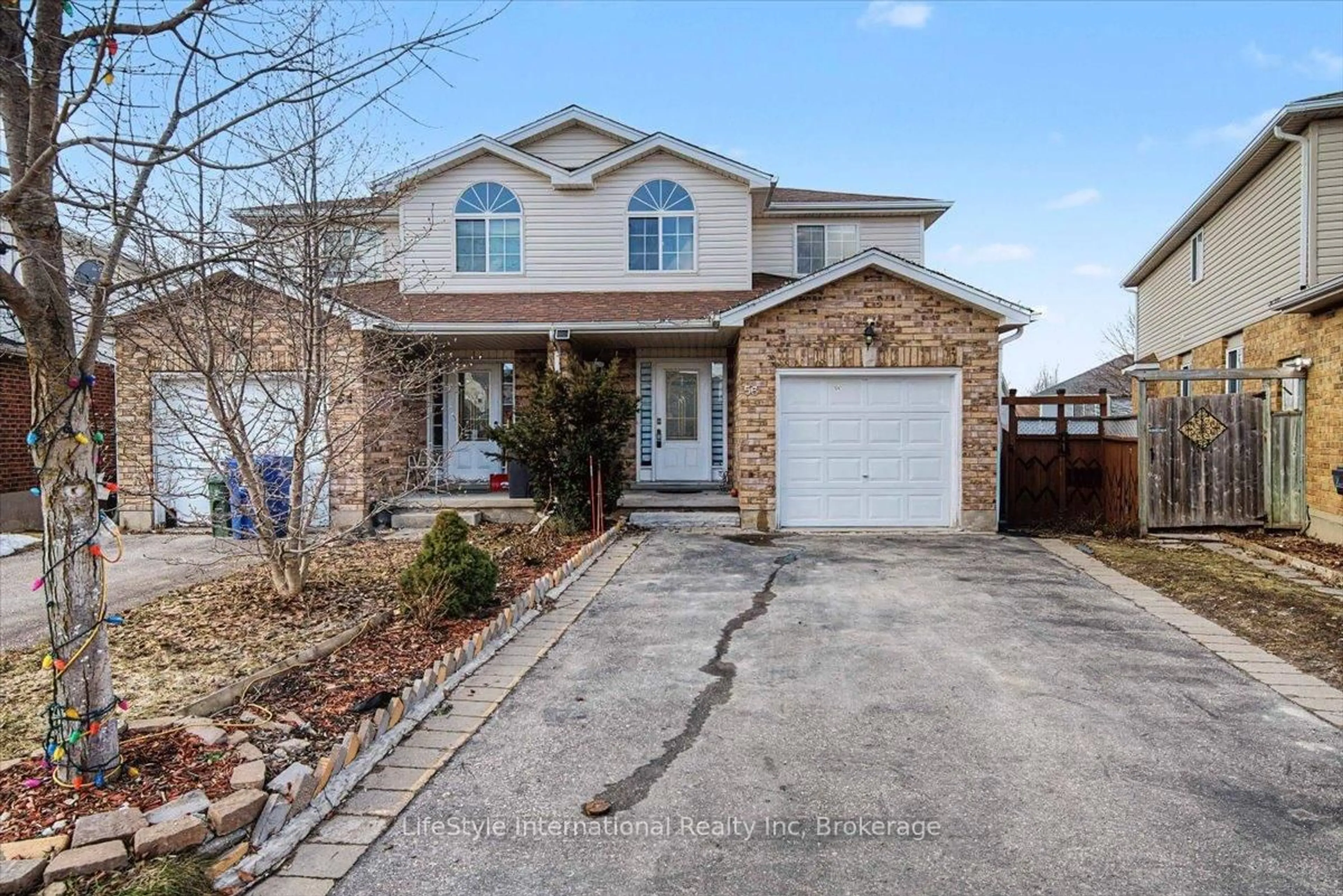 Home with brick exterior material, street for 56 Raspberry Lane, Guelph Ontario N1E 7H5