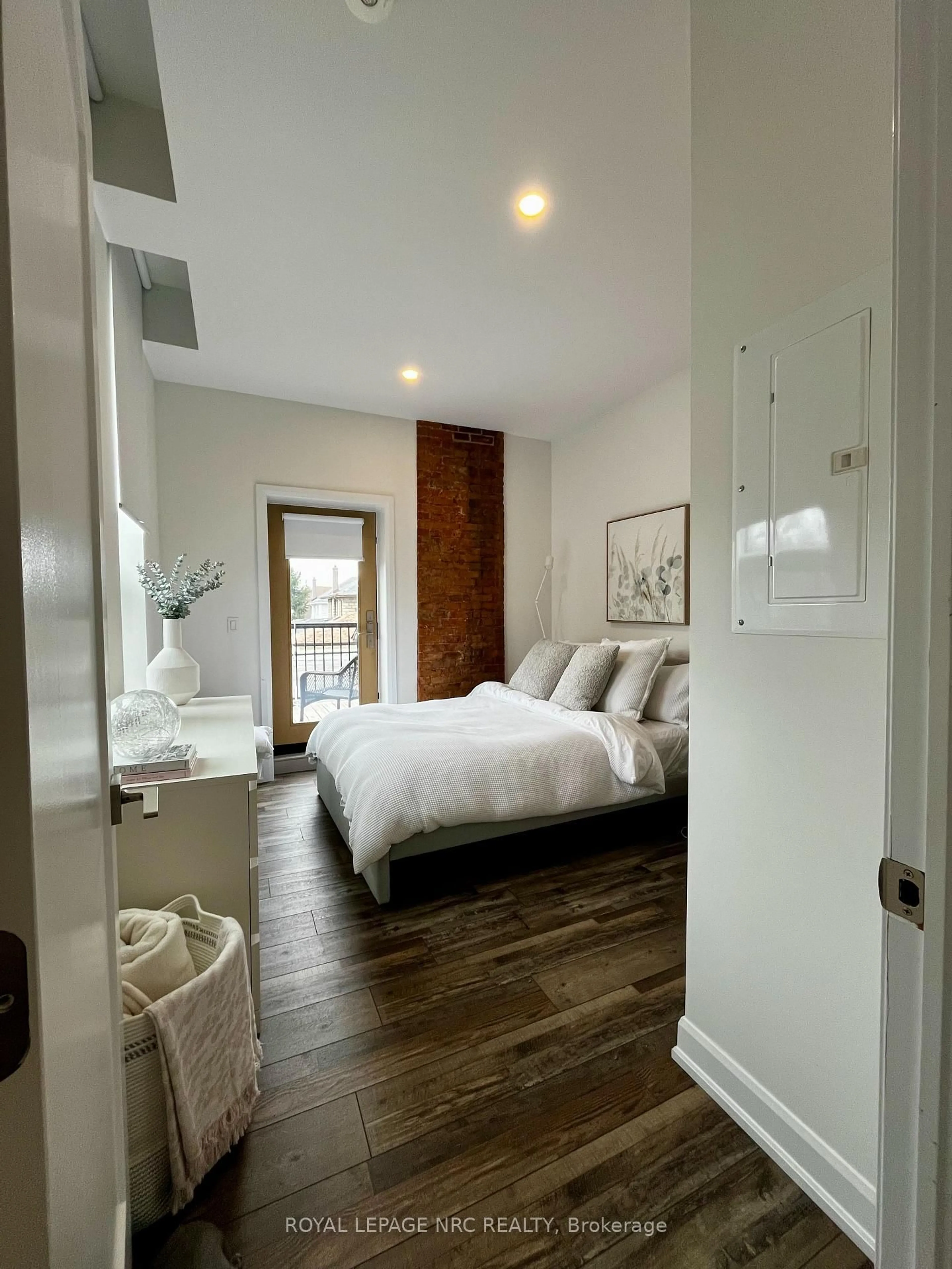 Bedroom with bed, wood/laminate floor for 405 Merritt St #12, St. Catharines Ontario L2P 1P5