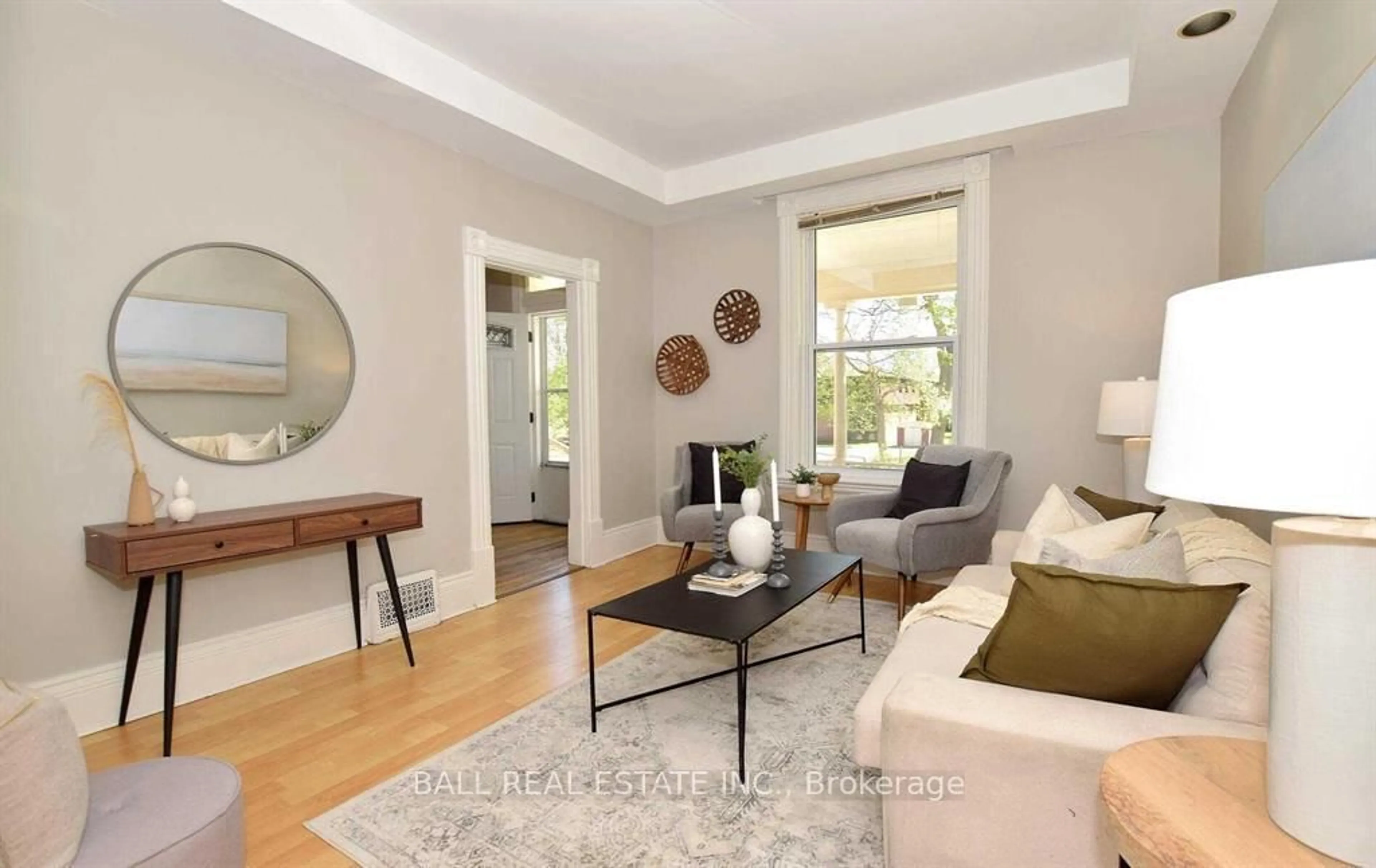 Living room with furniture, wood/laminate floor for 619 Aylmer St, Peterborough Ontario K9H 3X2