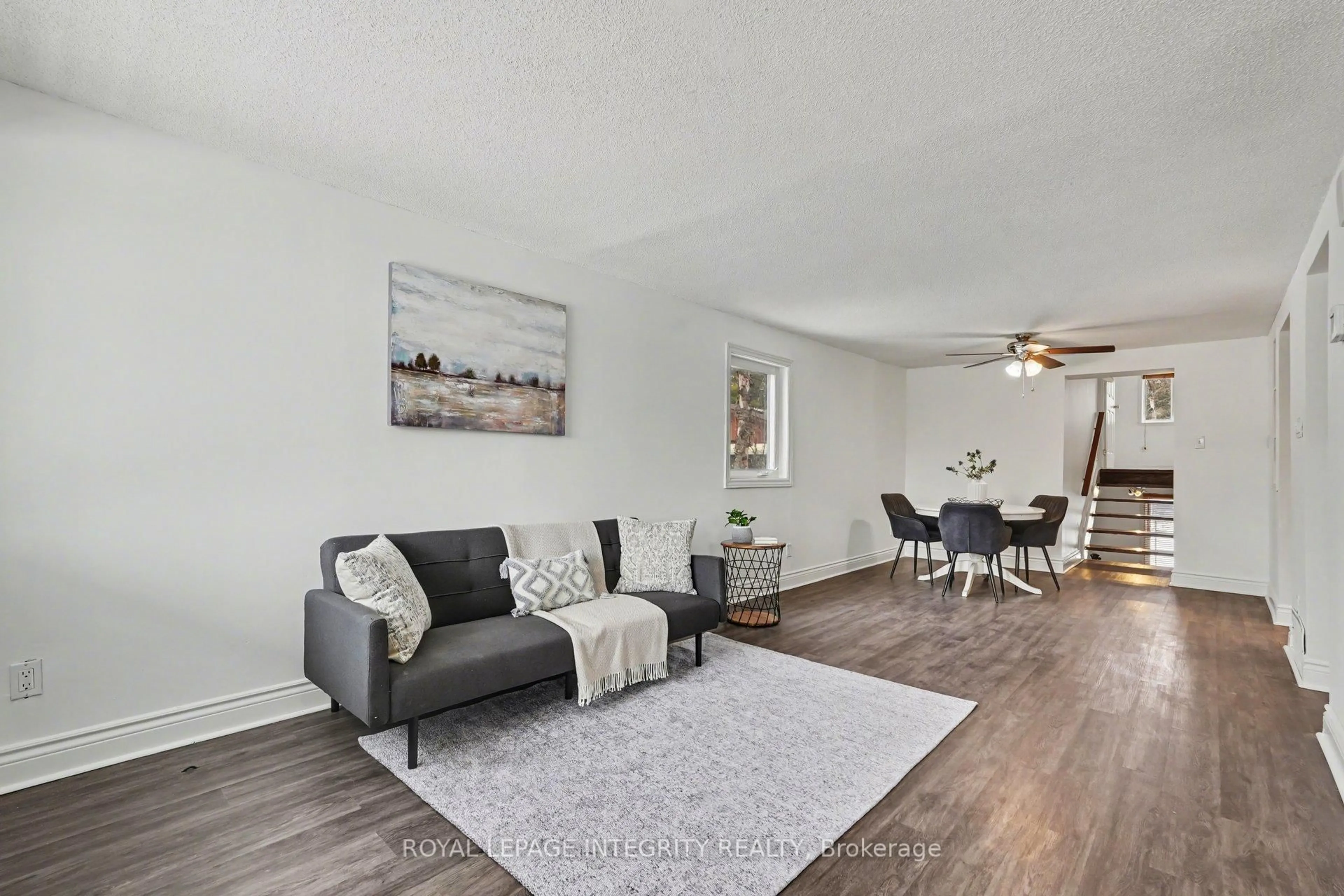 Living room with furniture, wood/laminate floor for 90 Constance Lake Rd, Ottawa Ontario K2K 1X7