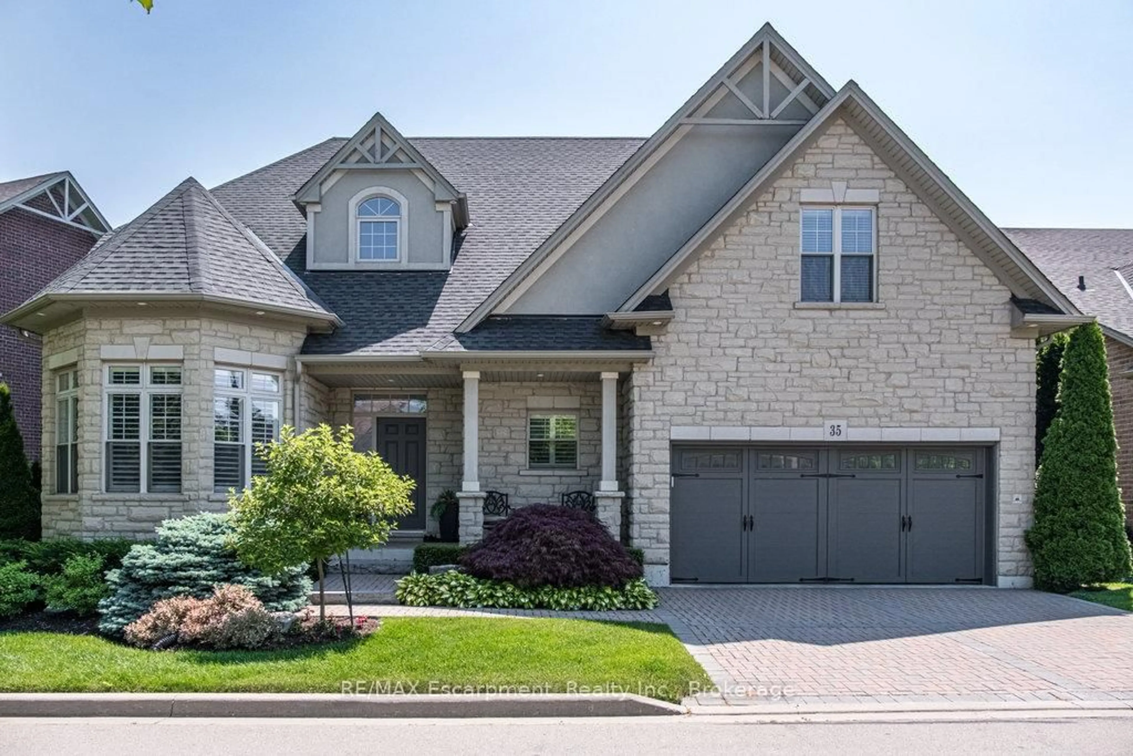 Home with brick exterior material, street for 35 Butternut Grove Lane, Hamilton Ontario L9K 0B7