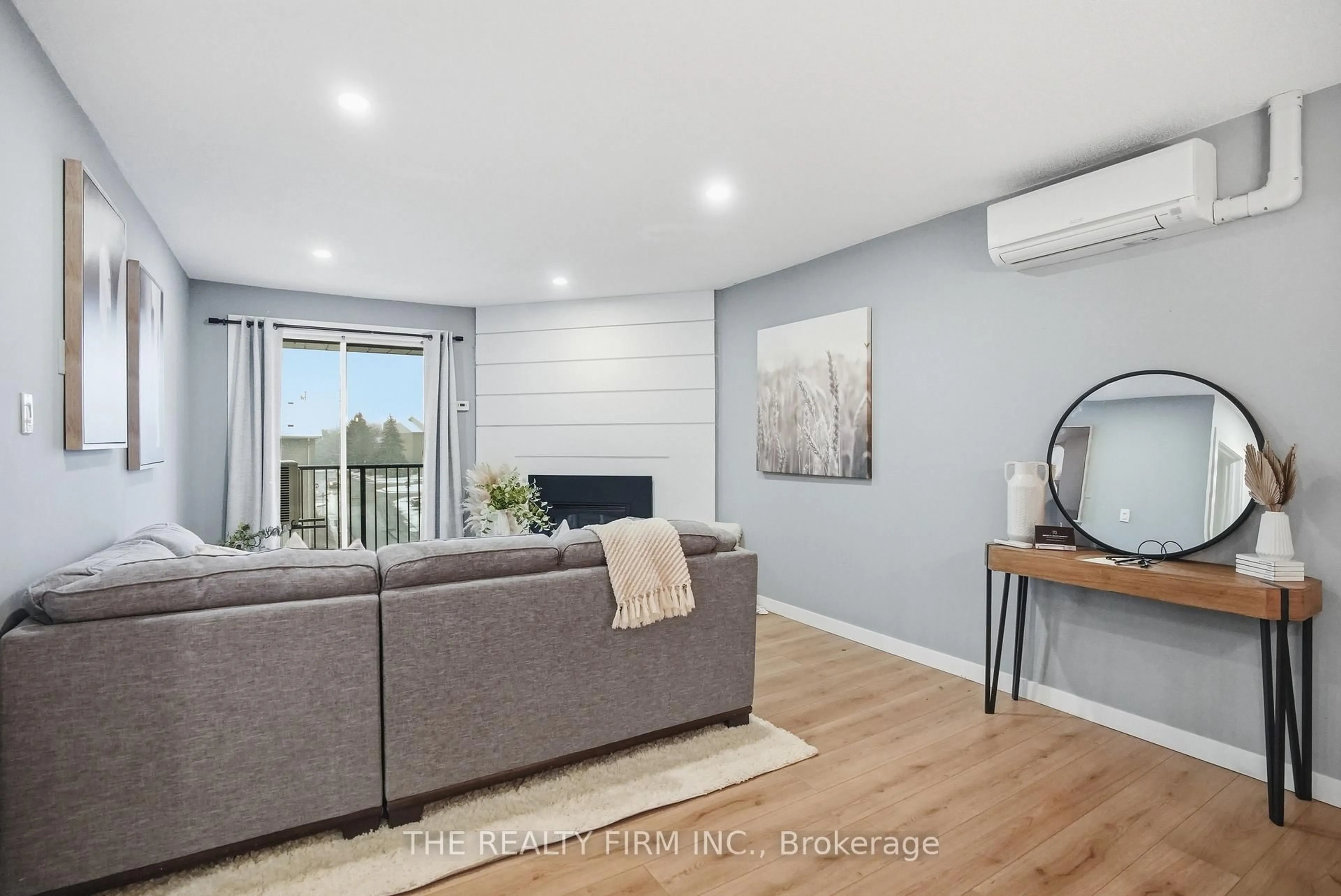 Living room with furniture, wood/laminate floor for 735 Deveron Cres #310, London South Ontario N5Z 4X8