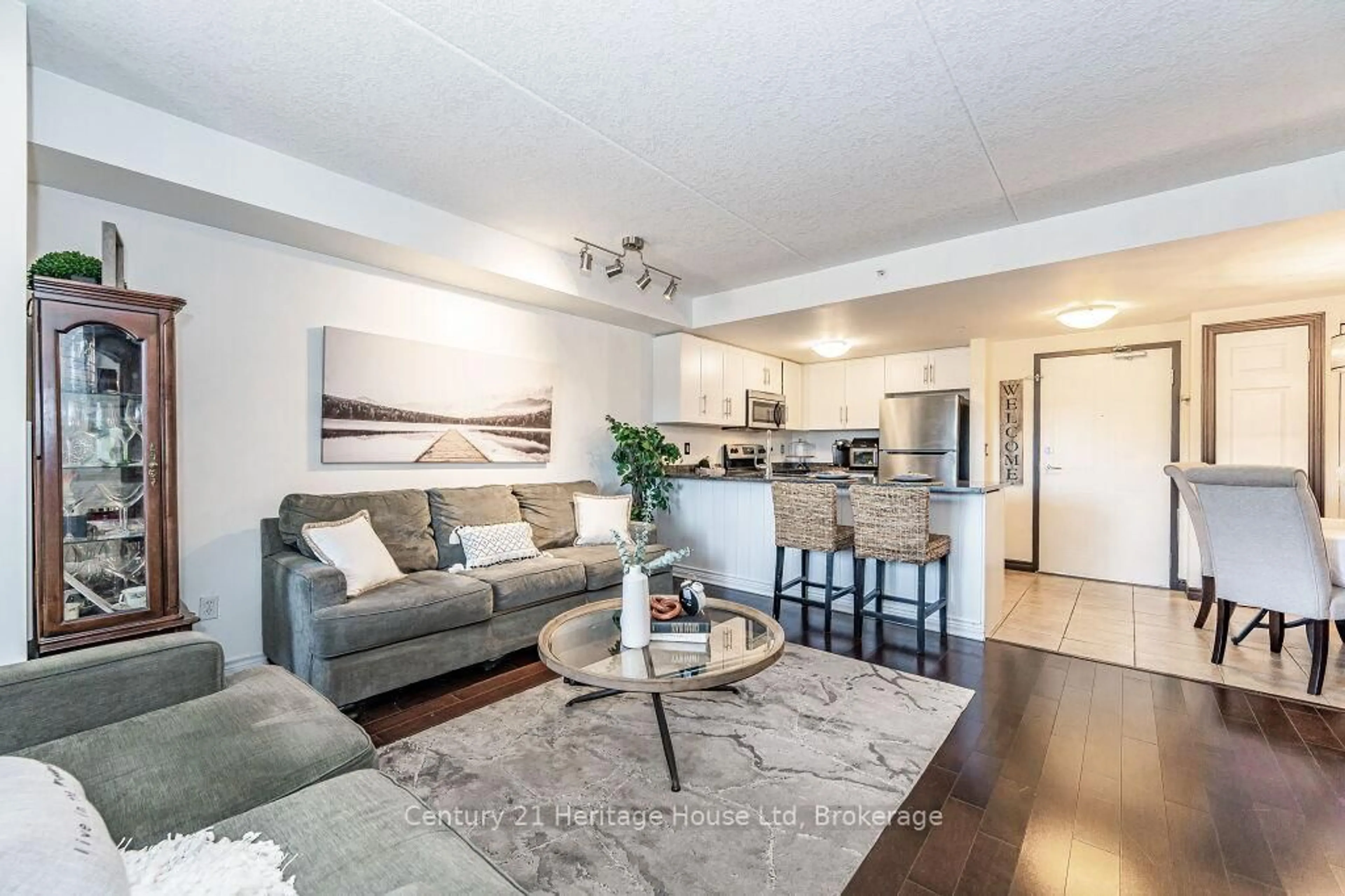 Living room with furniture, wood/laminate floor for 43 Goodwin Dr #212, Guelph Ontario N1L 0E5