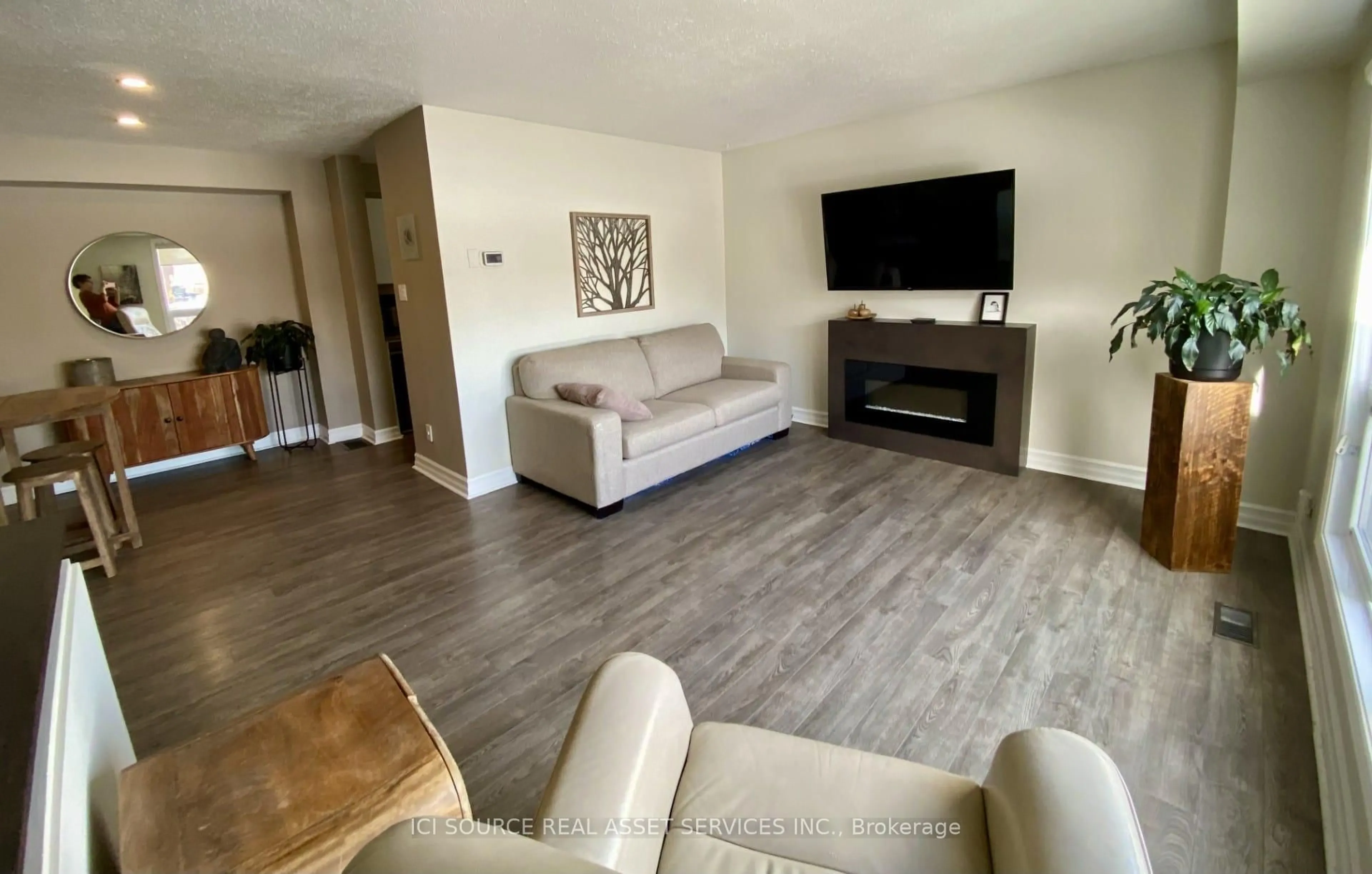 Living room with furniture, wood/laminate floor for 19D Forester Cres, Ottawa Ontario K2H 8Y1