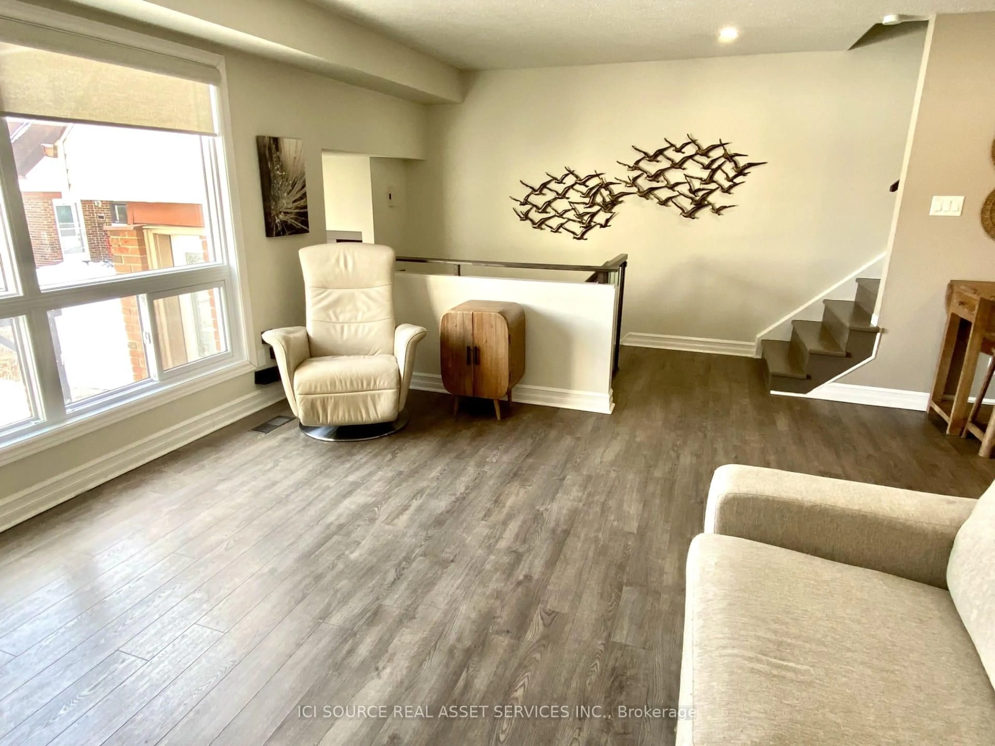 Living room with furniture, wood/laminate floor for 19D Forester Cres, Ottawa Ontario K2H 8Y1