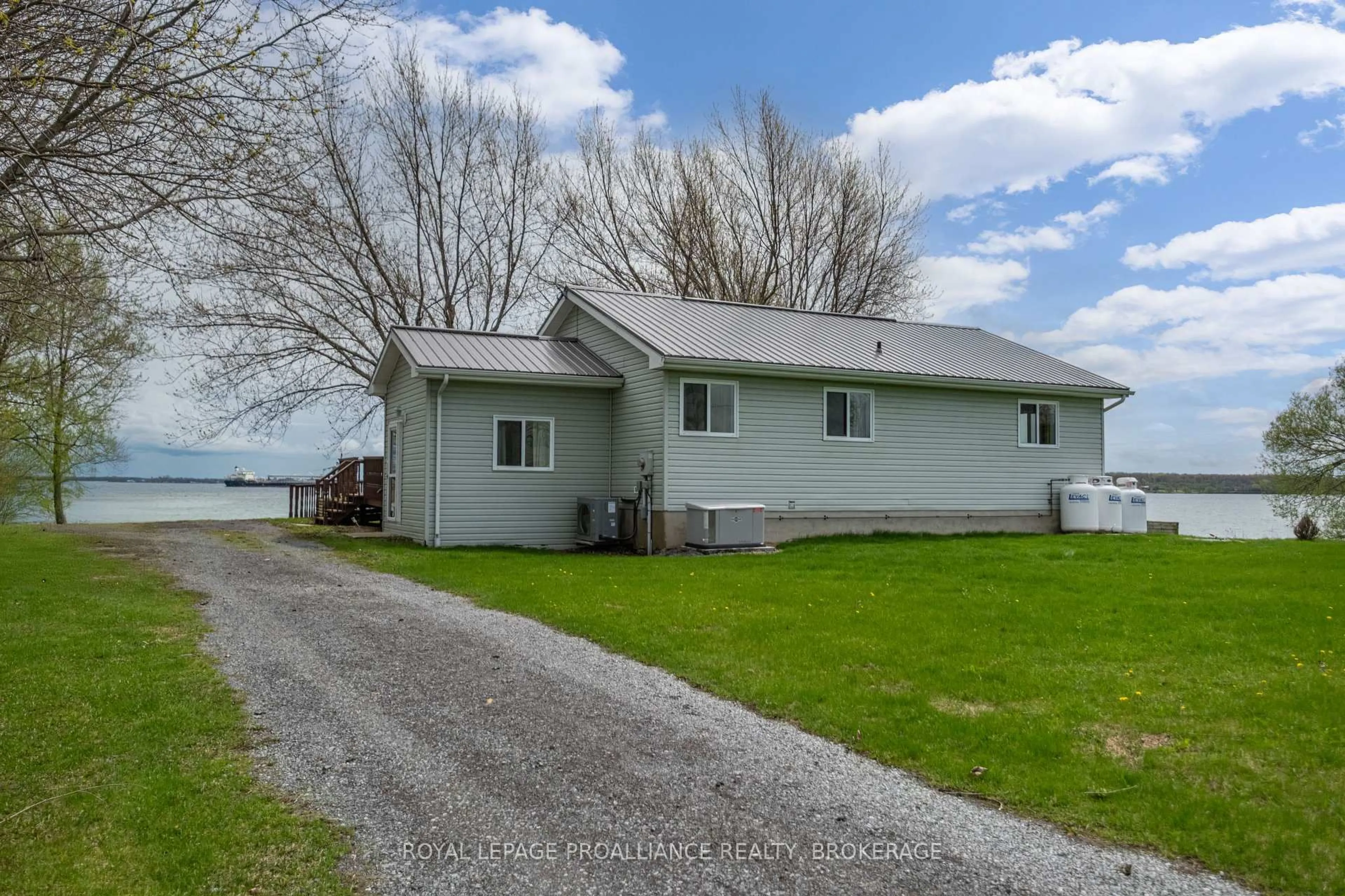 A pic from outside/outdoor area/front of a property/back of a property/a pic from drone, water/lake/river/ocean view for 4205 Highway 96, Wolfe Island Ontario K0H 2Y0