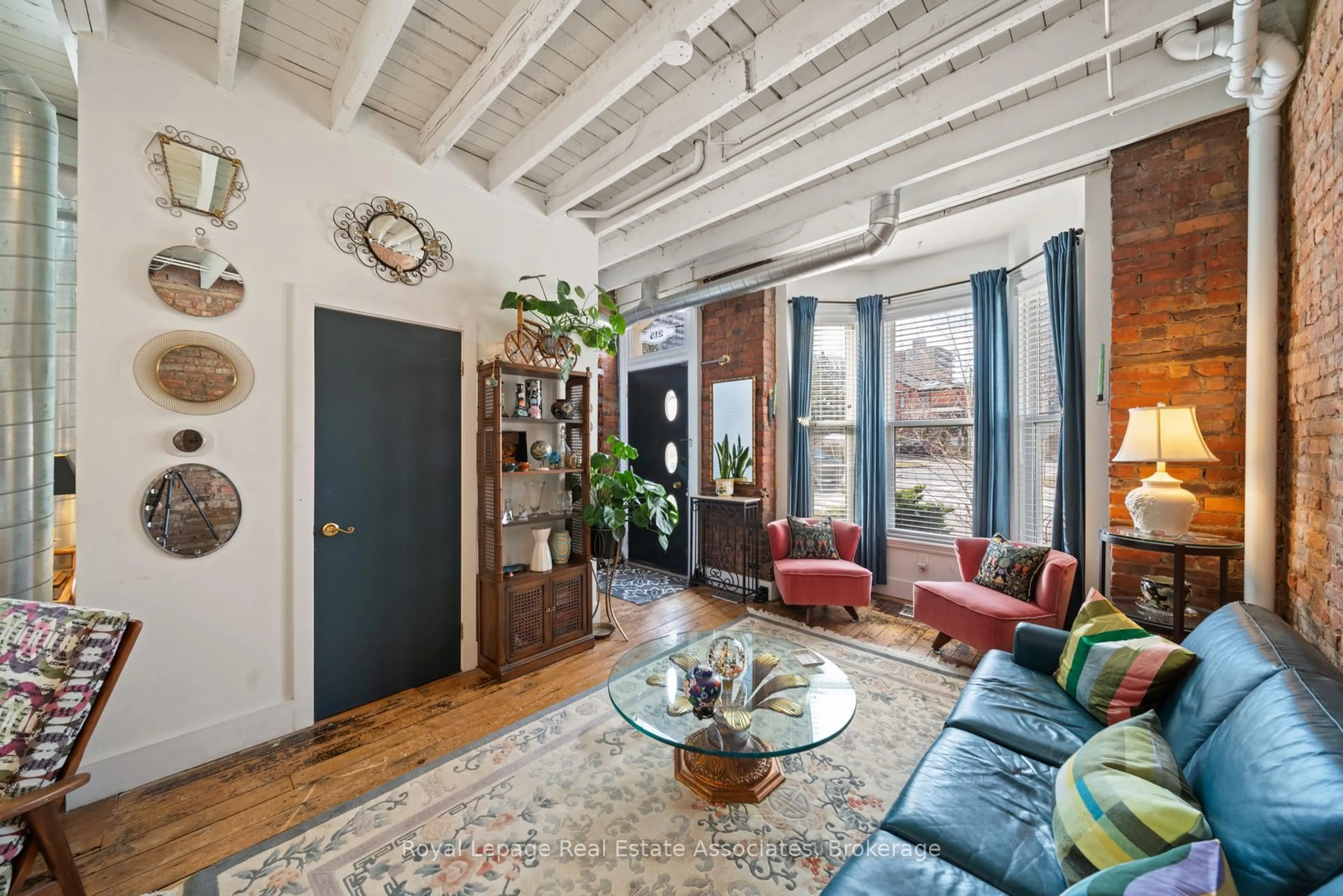 Living room with furniture, cement floor for 215 Ferguson Ave, Hamilton Ontario L8N 2N2