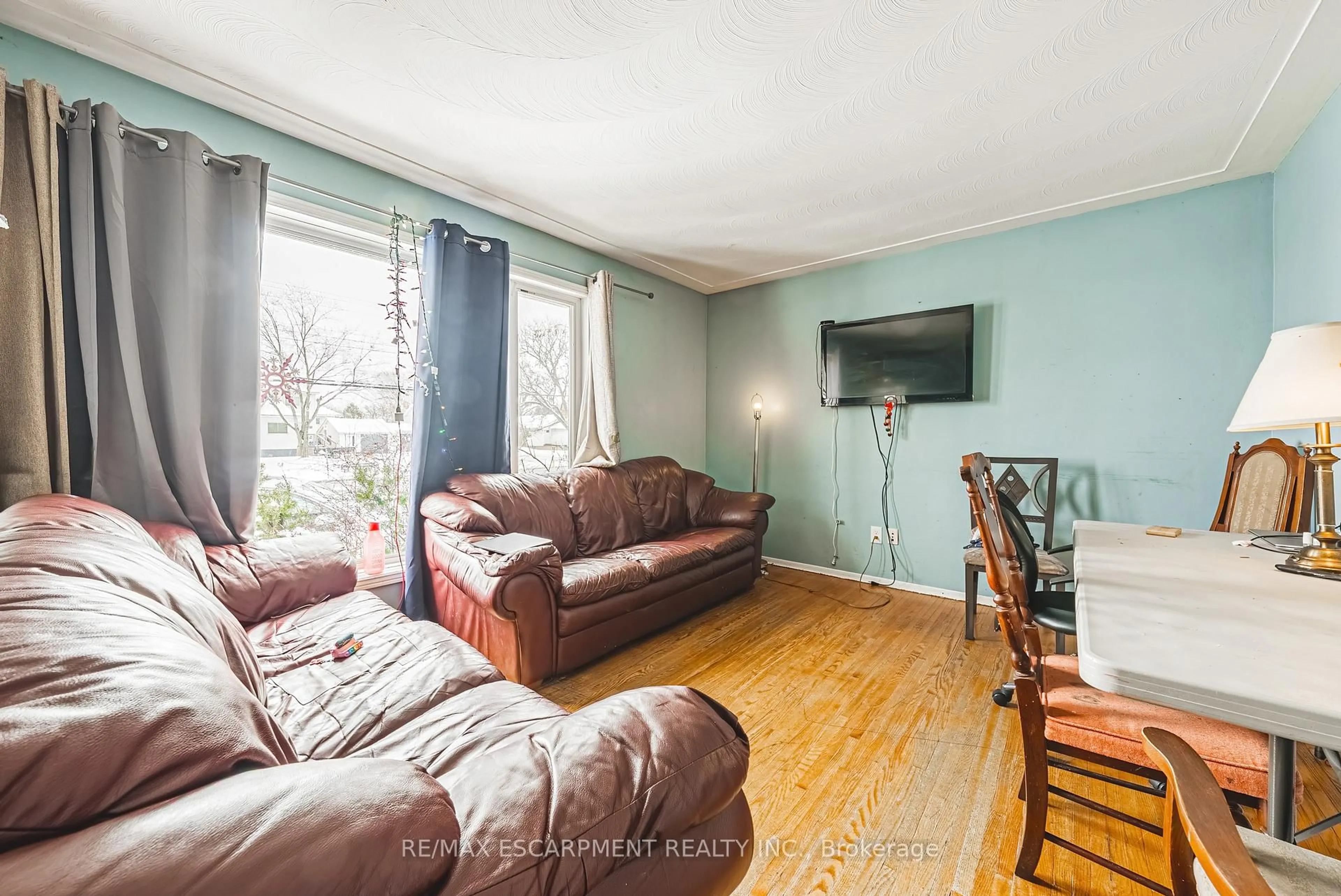 Living room with furniture, wood/laminate floor for 928 Upper Gage Ave, Hamilton Ontario L8V 4K9