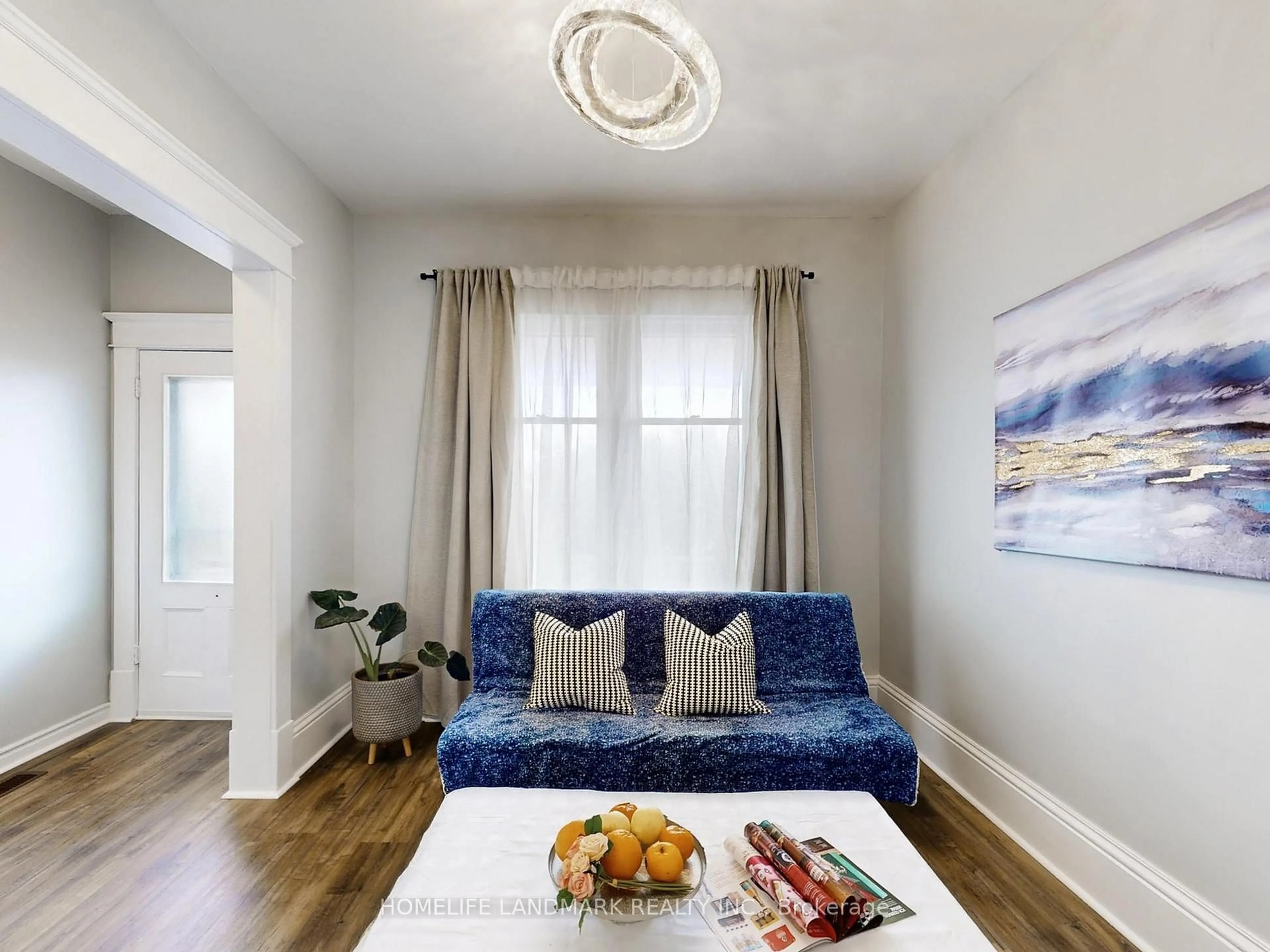 Living room with furniture, wood/laminate floor for 674 Colborne St, Brantford Ontario N3S 3P9