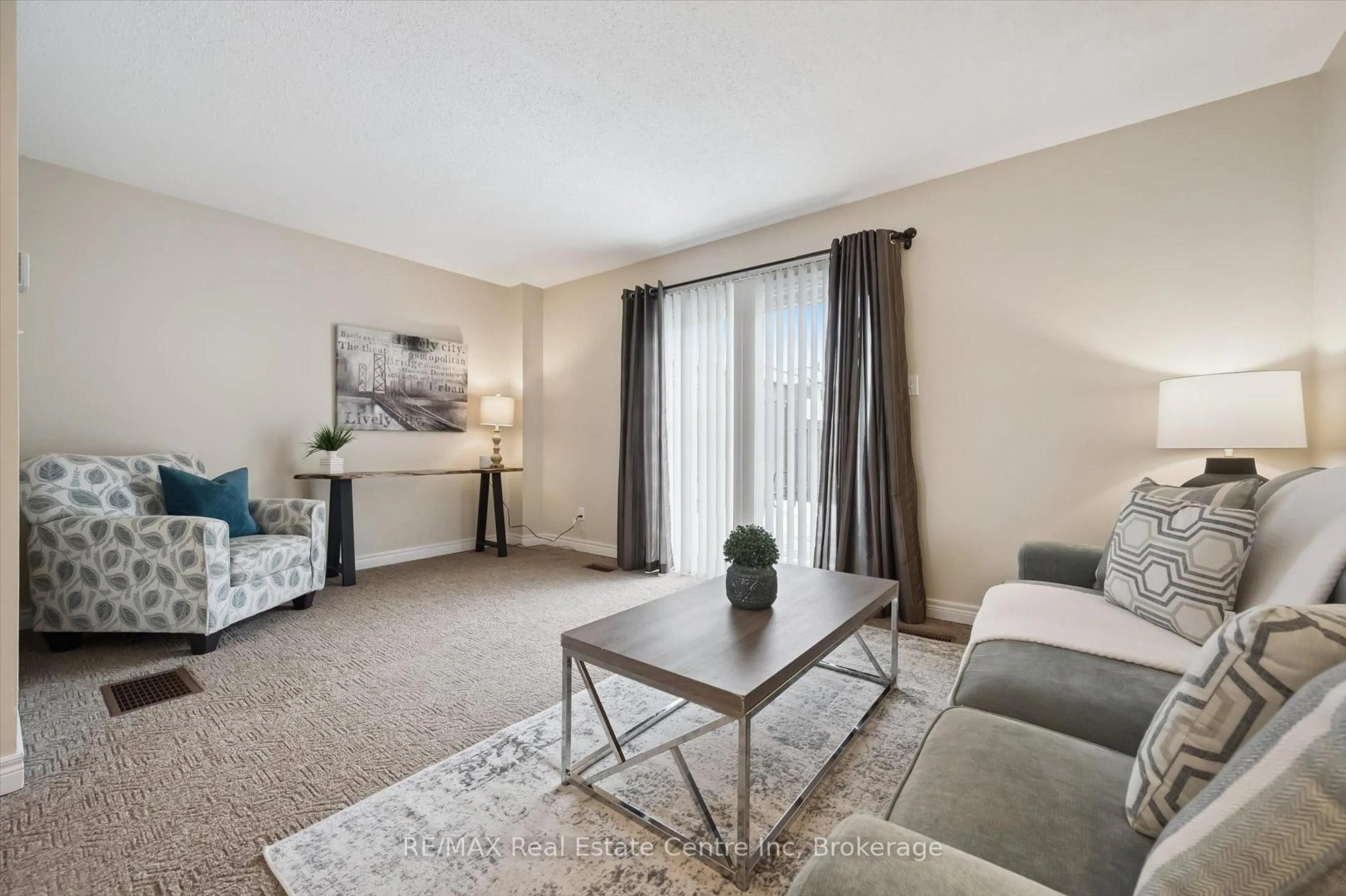 Living room with furniture, carpet floor for 31 Greengate Rd #205, Guelph Ontario N1H 6R3