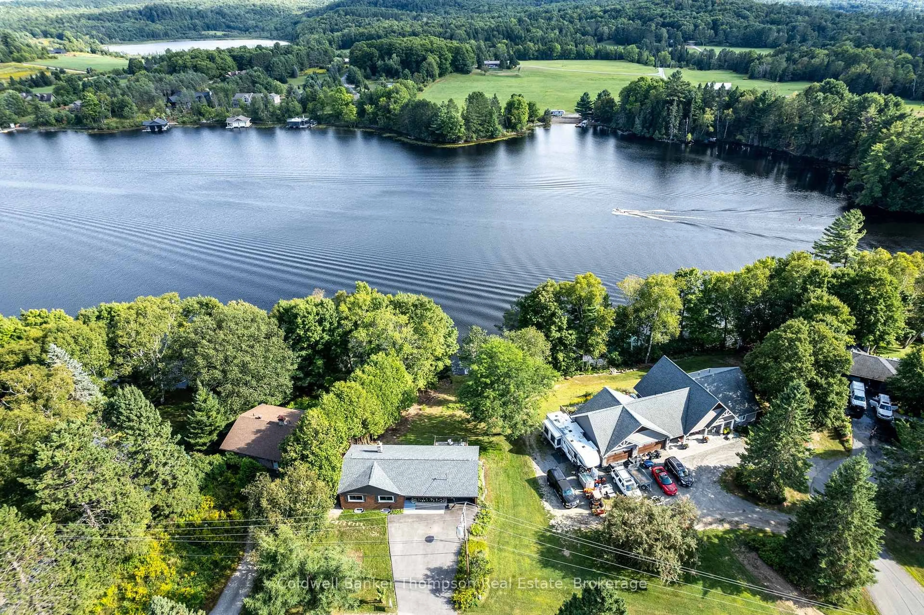 A pic from outside/outdoor area/front of a property/back of a property/a pic from drone, water/lake/river/ocean view for 109 Riverside Dr, Huntsville Ontario P1H 1R6