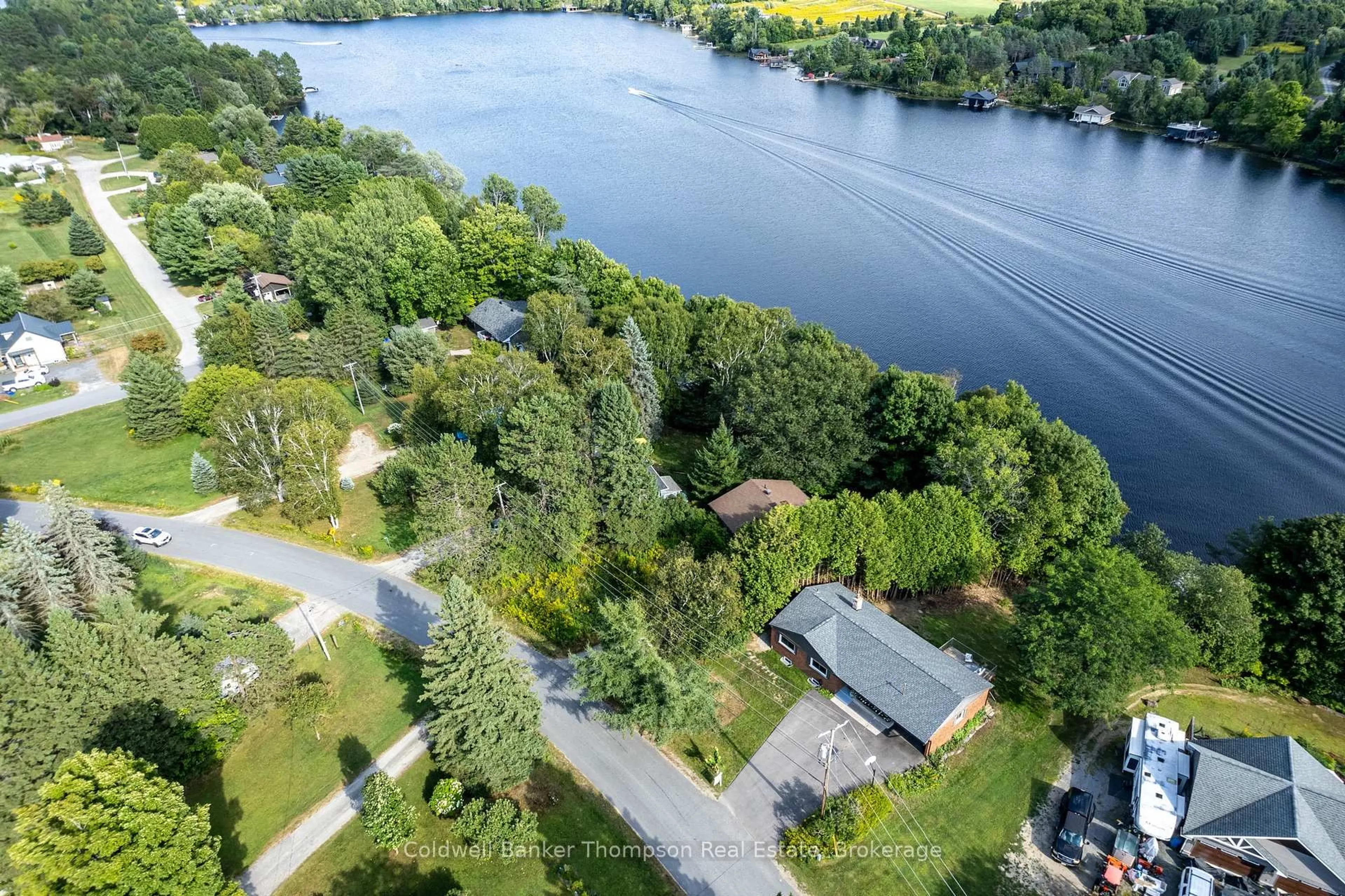 A pic from outside/outdoor area/front of a property/back of a property/a pic from drone, water/lake/river/ocean view for 109 Riverside Dr, Huntsville Ontario P1H 1R6