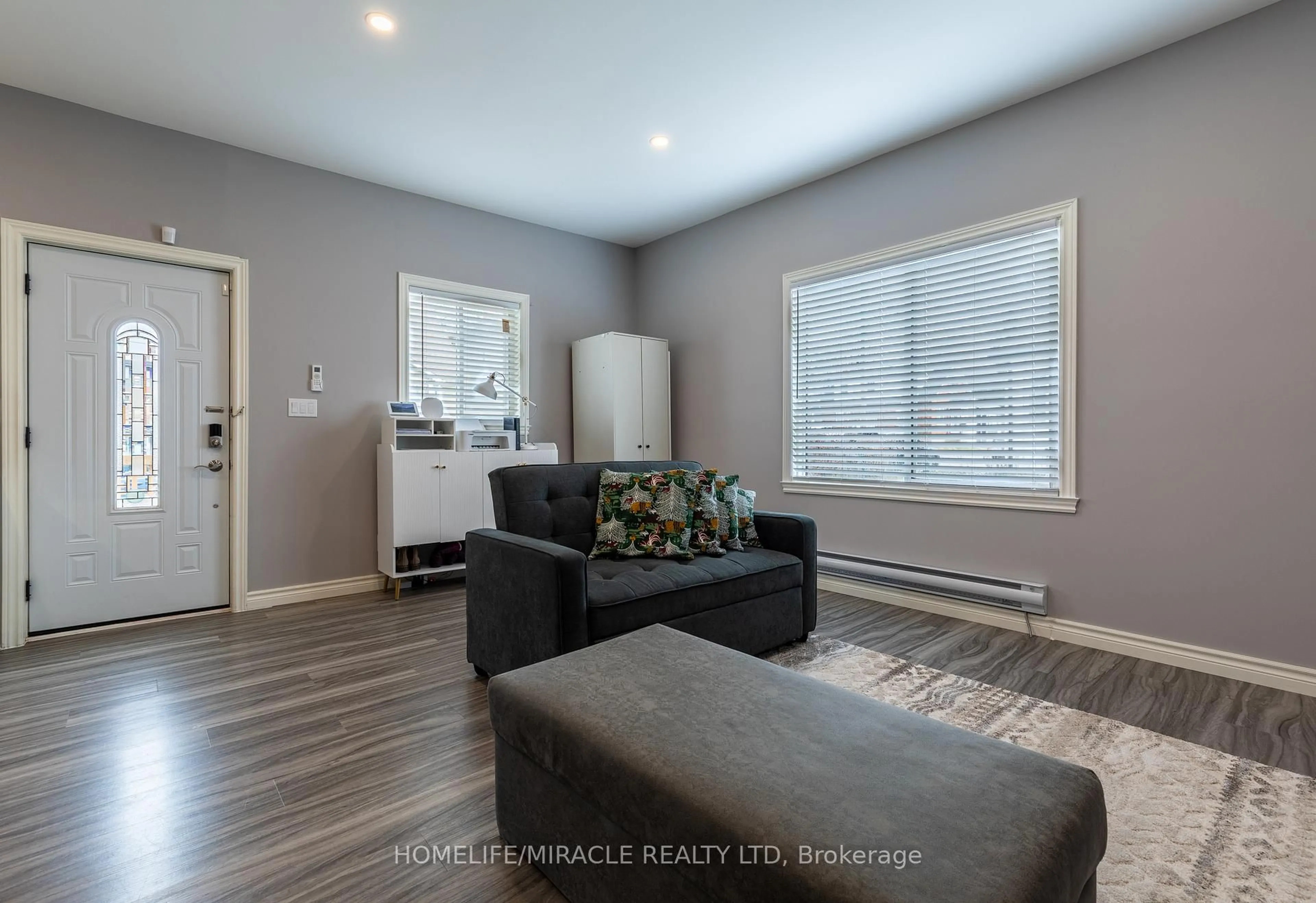 Living room with furniture, wood/laminate floor for 36 Division St, St. Catharines Ontario L2R 3G2