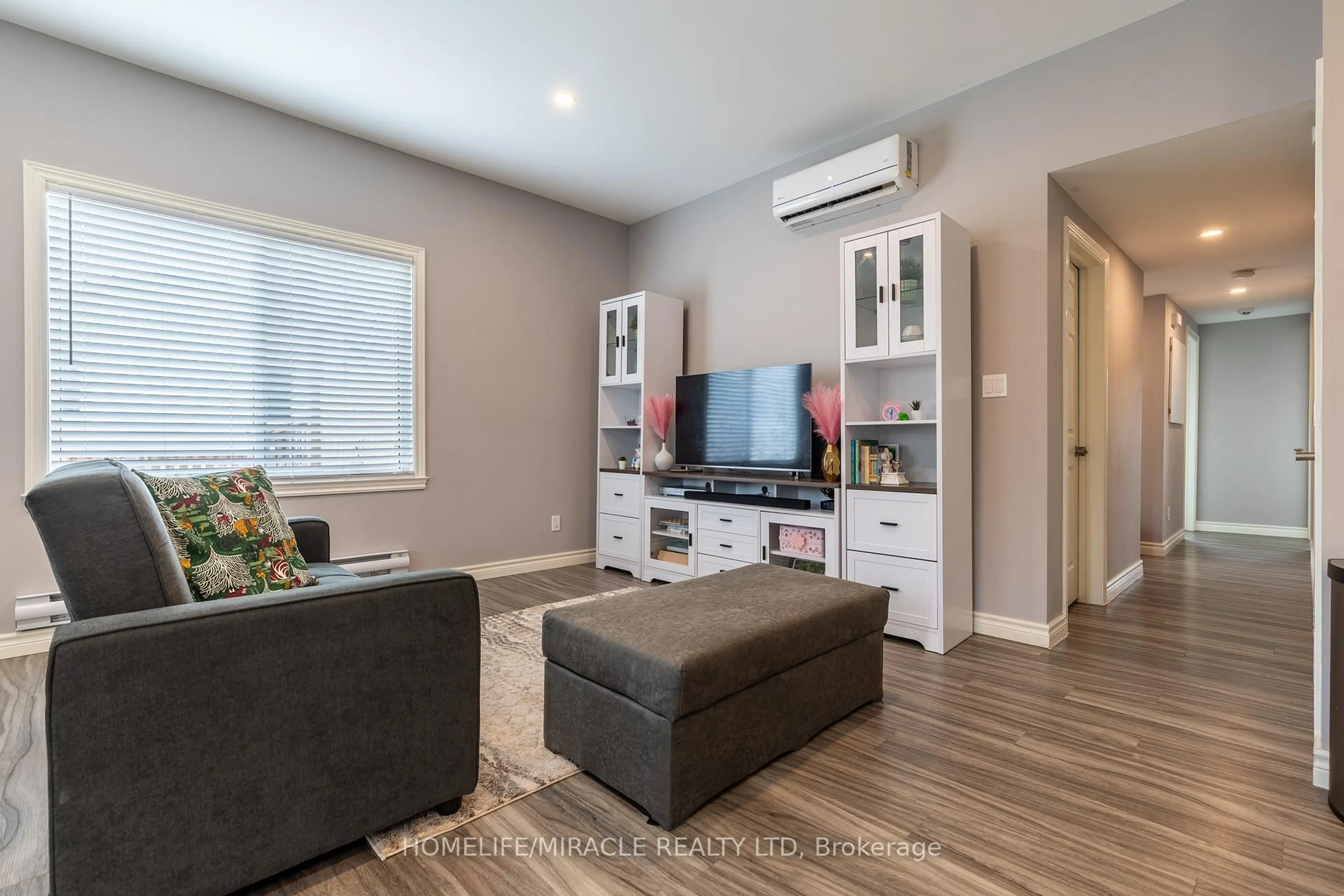 Living room with furniture, wood/laminate floor for 36 Division St, St. Catharines Ontario L2R 3G2