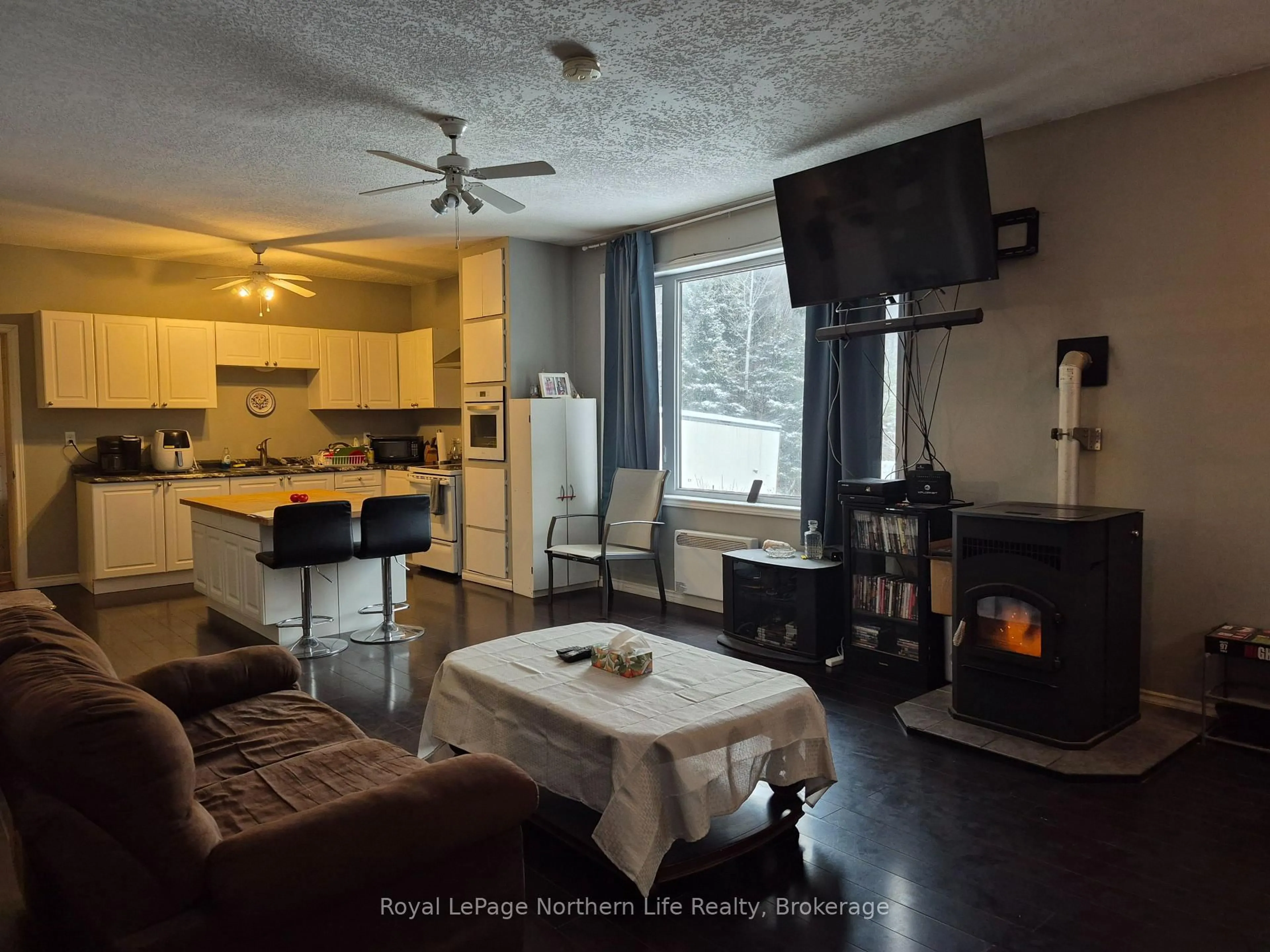 Living room with furniture, wood/laminate floor for 26 ARBUTUS Tr, Mattawan Ontario P0H 1V0