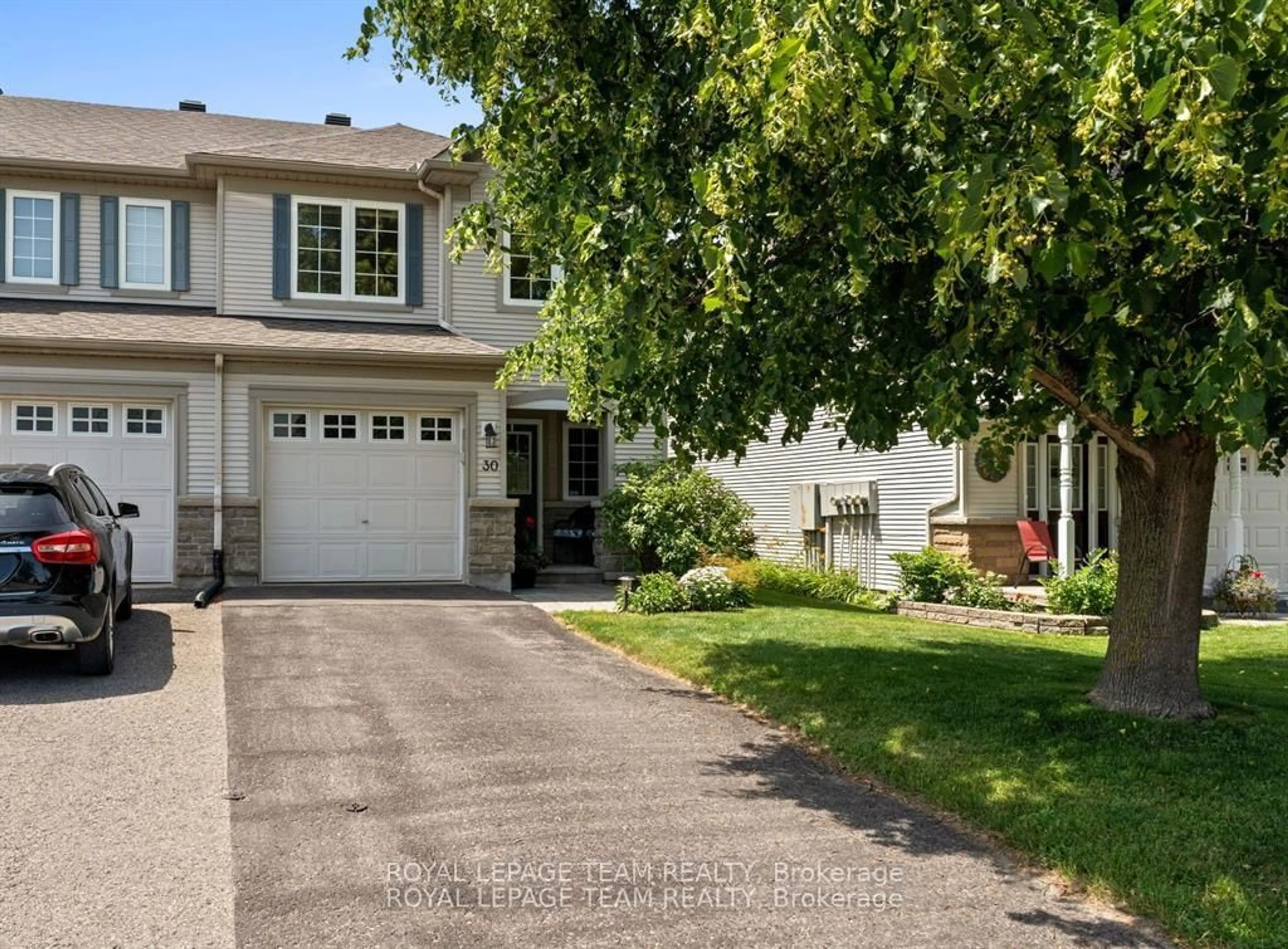 Home with vinyl exterior material, street for 30 Riverstone Dr, Ottawa Ontario K2J 4X7