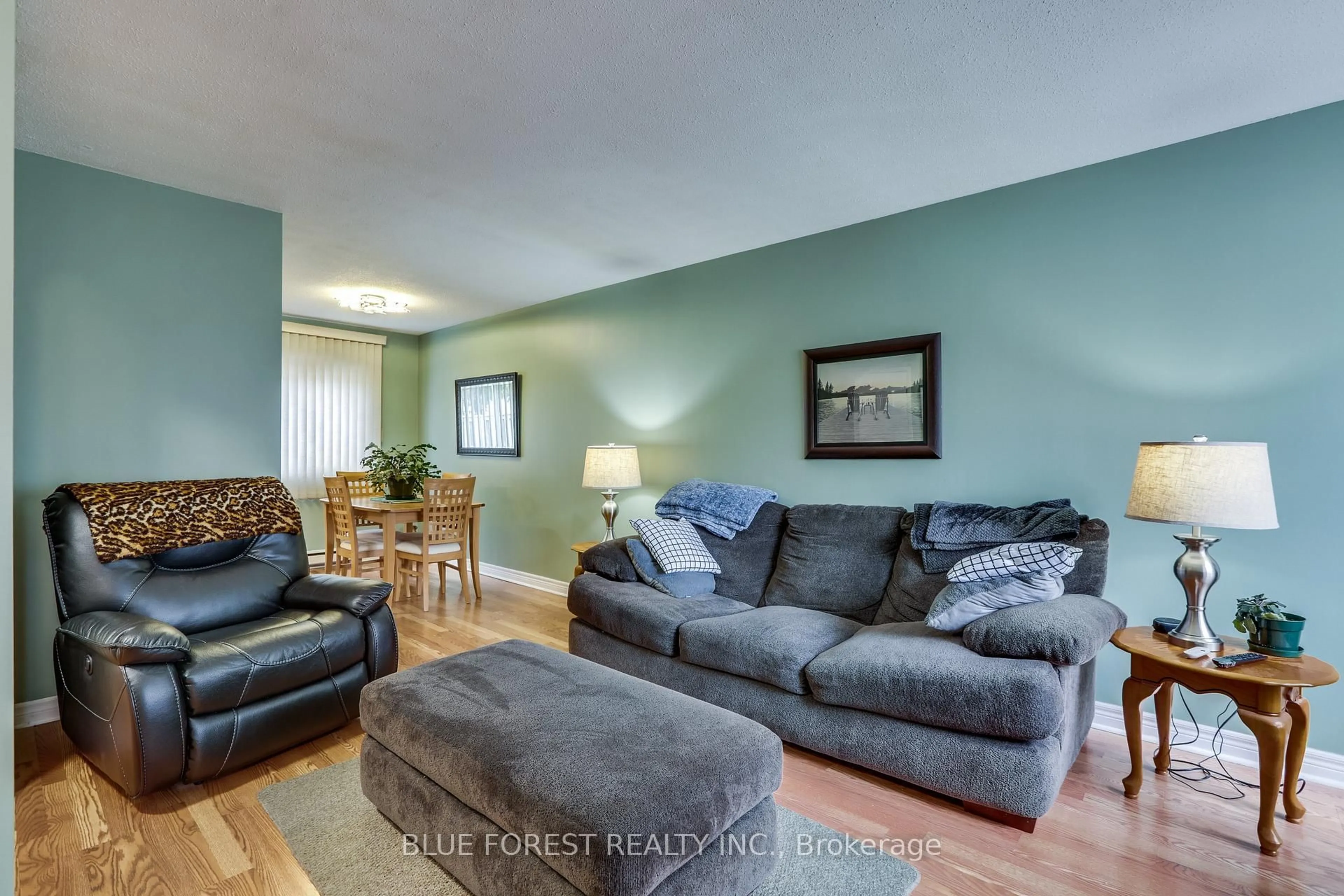 Living room with furniture, wood/laminate floor for 166 Southdale Rd #54, London South Ontario N6J 2J1