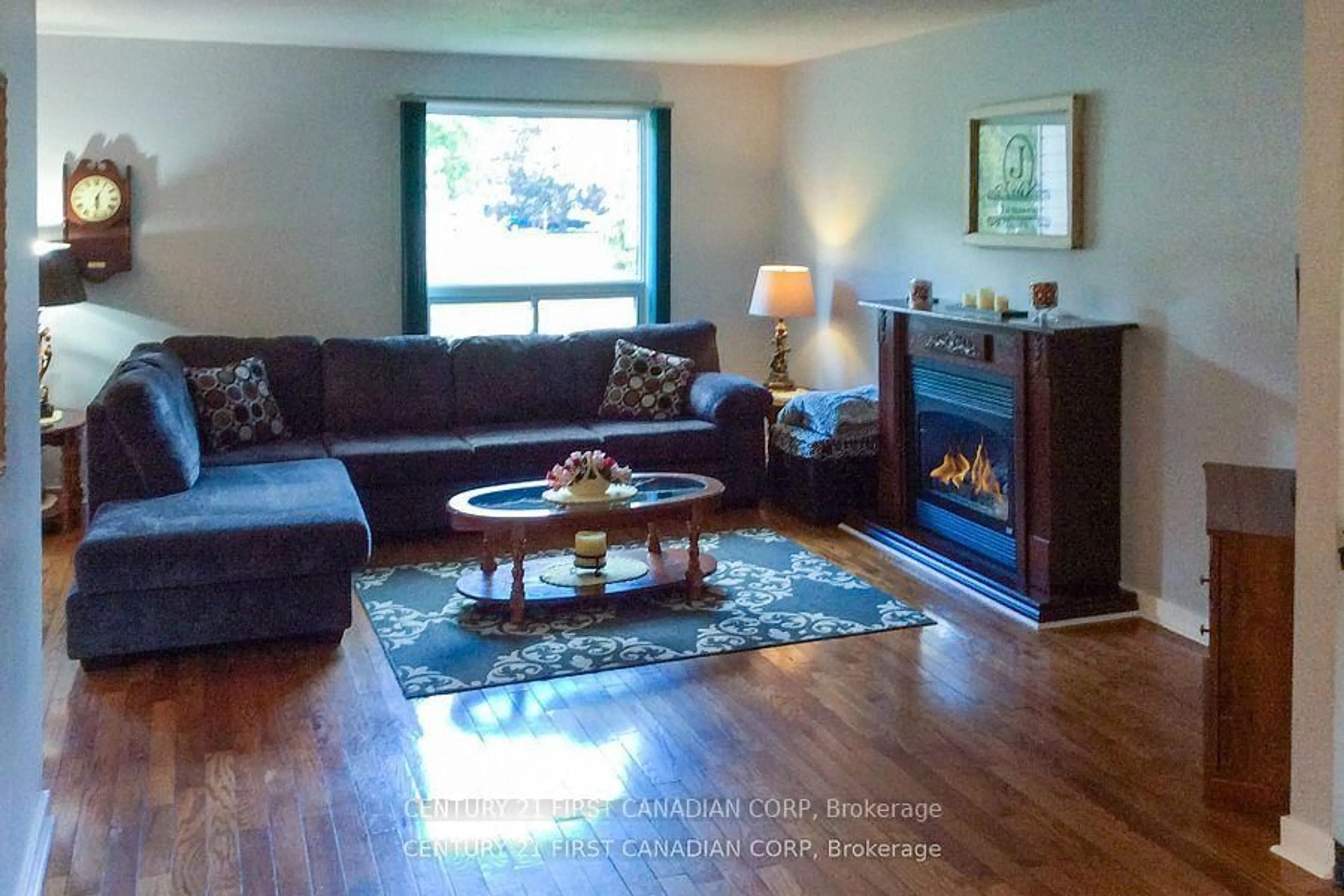 Living room with furniture, wood/laminate floor for 106 Angelo Dr, West Elgin Ontario N0L 2P0