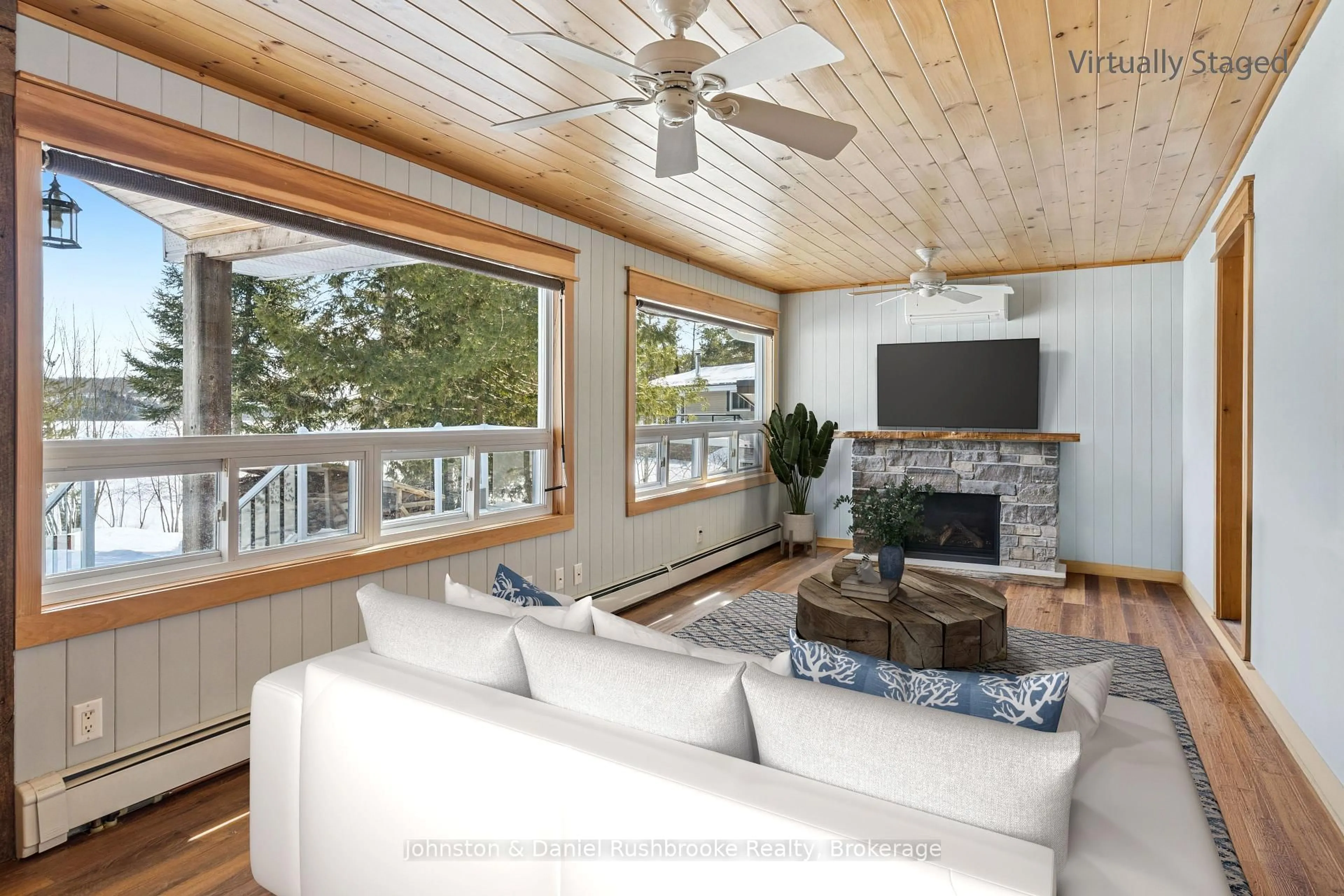 Living room with furniture, wood/laminate floor for 1075 Sandwood Dr, Muskoka Lakes Ontario P0B 1M0