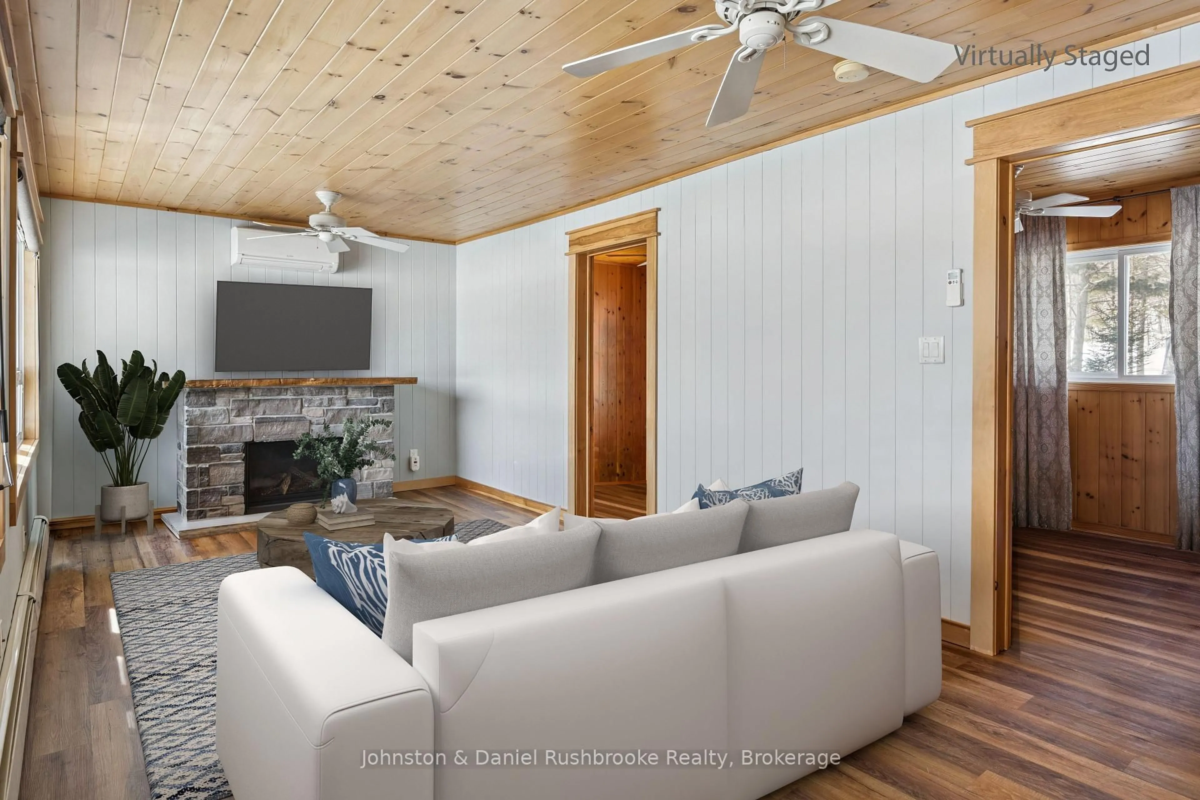Living room with furniture, wood/laminate floor for 1075 Sandwood Dr, Muskoka Lakes Ontario P0B 1M0