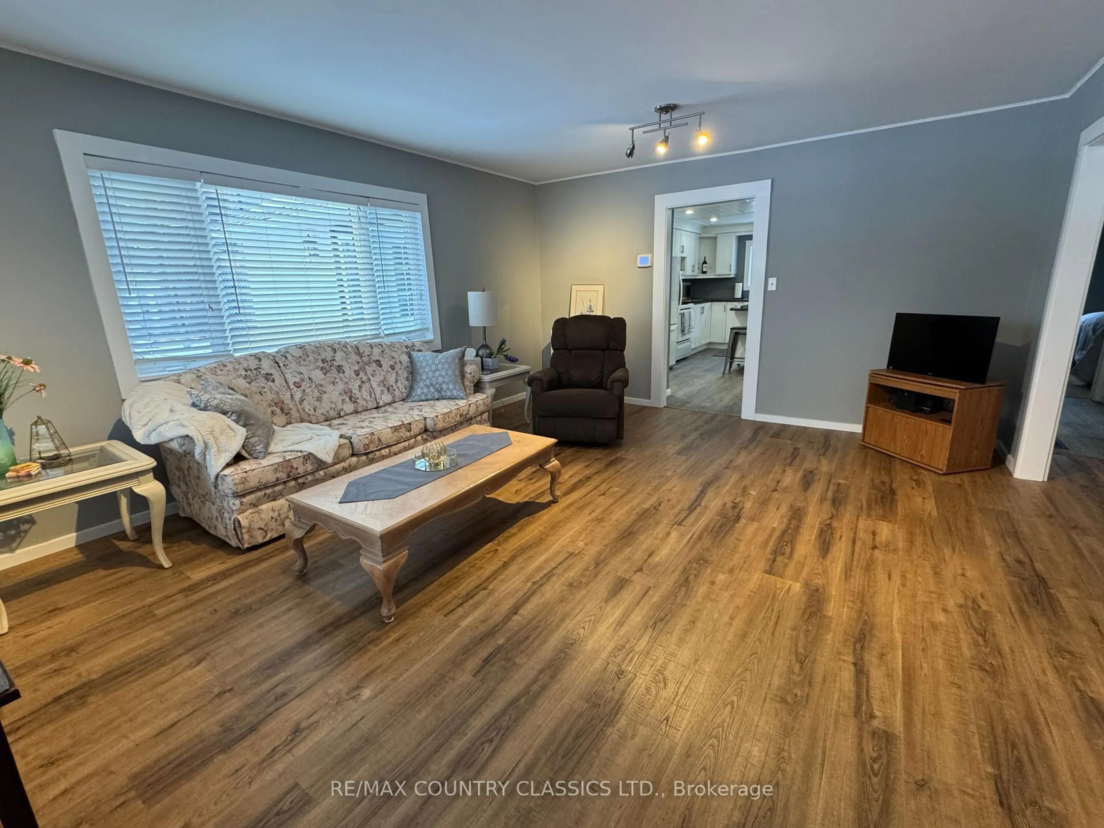 Living room with furniture, wood/laminate floor for 38 Flint Ave, Bancroft Ontario K0L 1C0