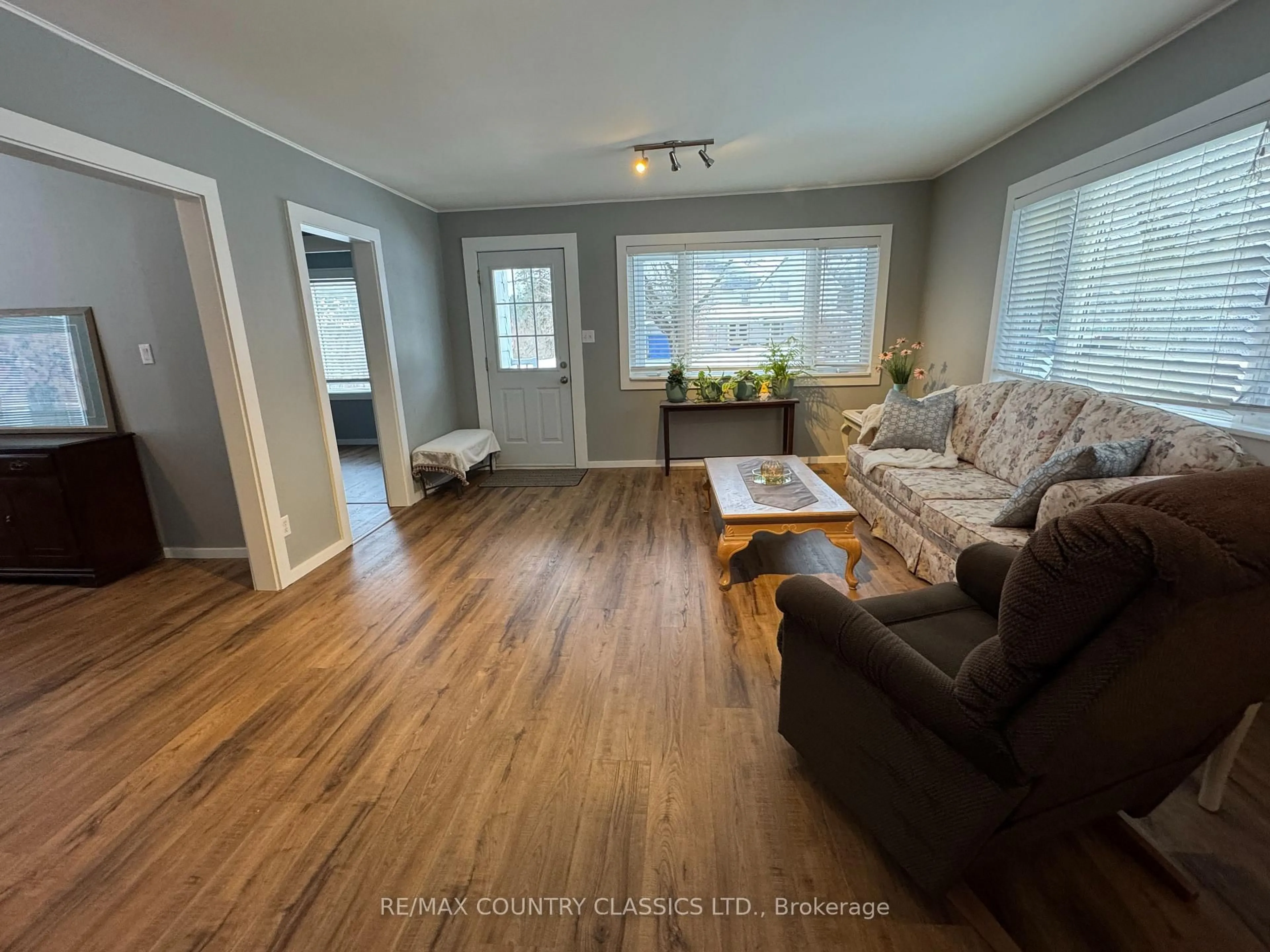 Living room with furniture, wood/laminate floor for 38 Flint Ave, Bancroft Ontario K0L 1C0
