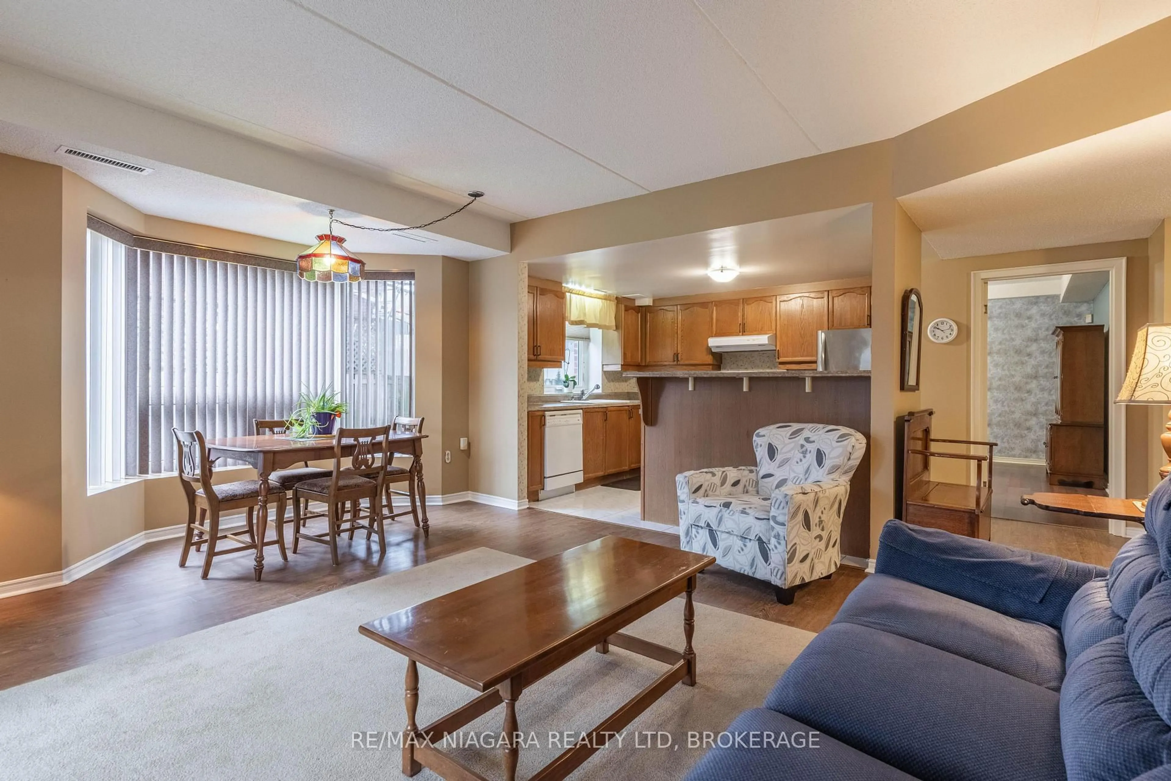 Living room with furniture, wood/laminate floor for 6704 Thorold Stone Rd #102, Niagara Falls Ontario L2J 1B3