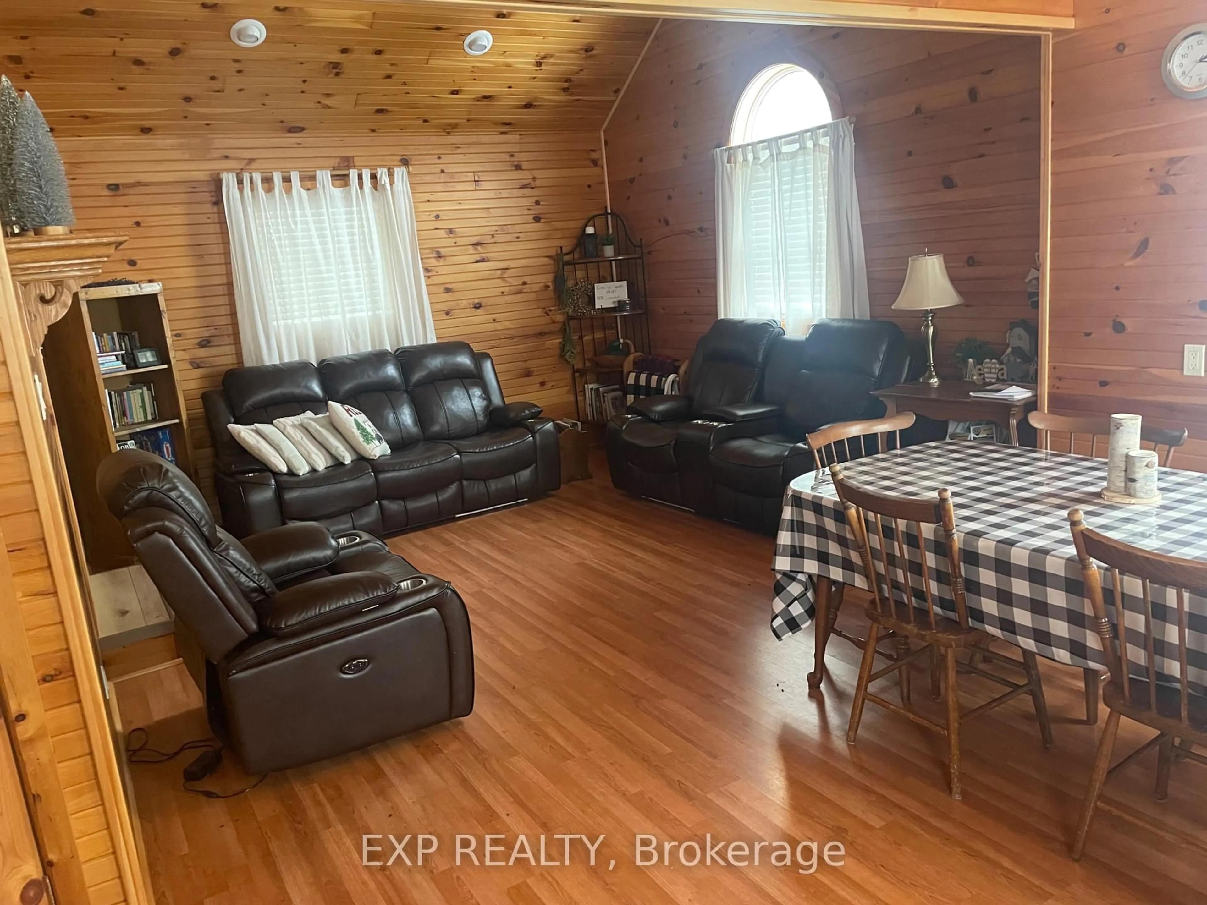Living room with furniture, wood/laminate floor for 35 Paradise Rd, South Algonquin Ontario K0J 2M0