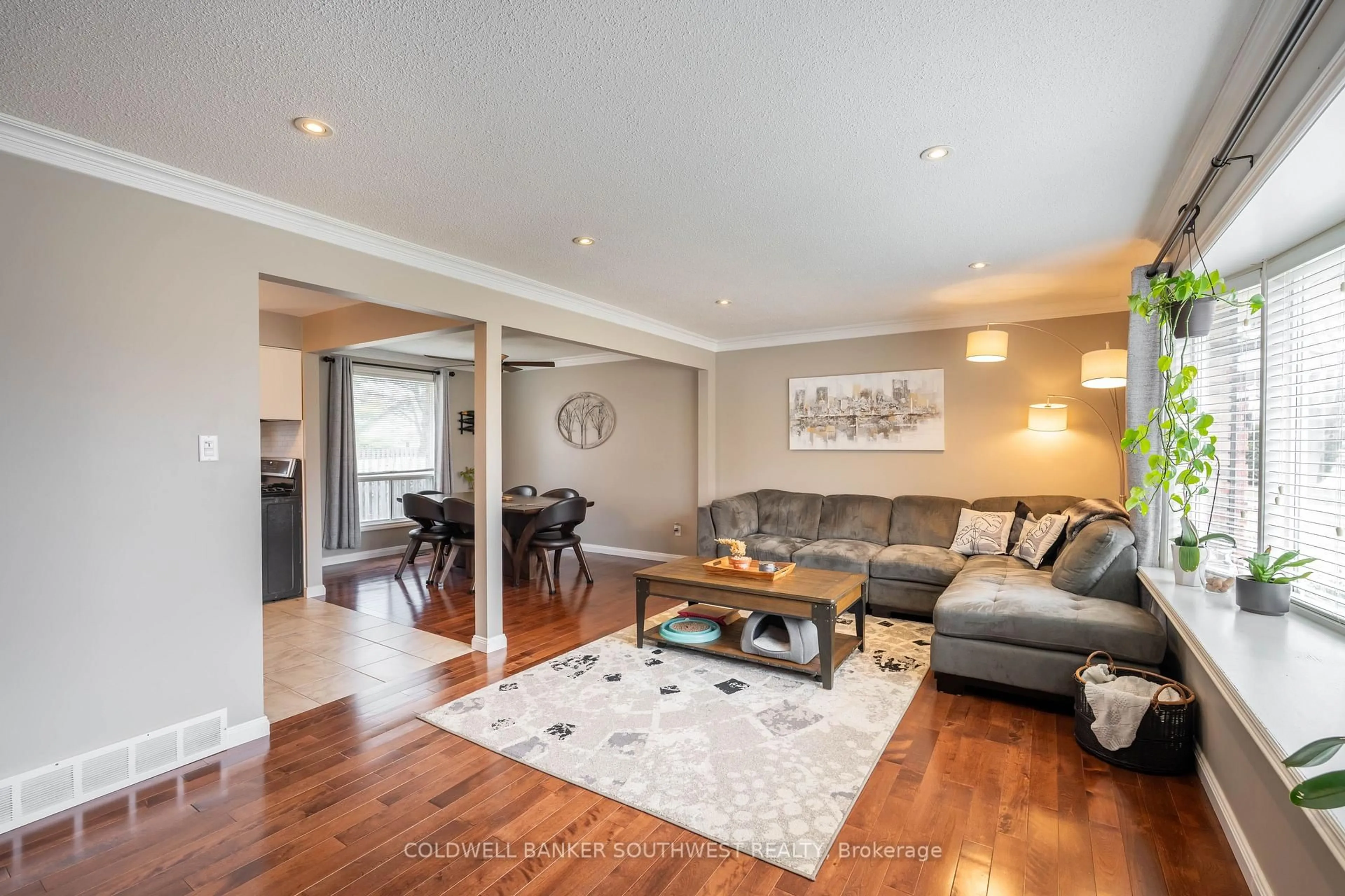 Living room with furniture, wood/laminate floor for 668 Winchester Cres, Sarnia Ontario N7S 4P5